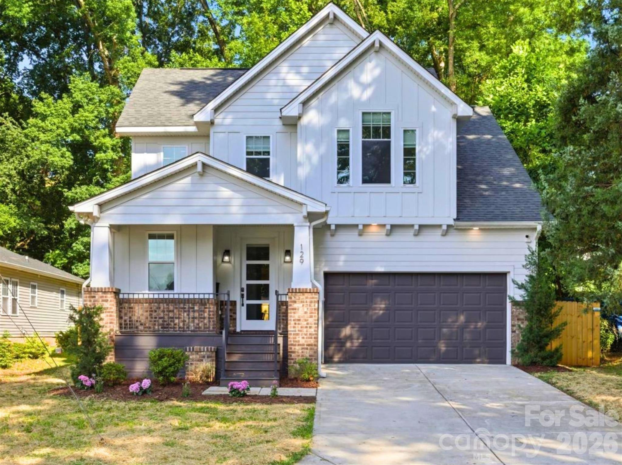 Just minutes from Uptown Charlotte, this stunning 2022 custom-built home in Smallwood offers modern luxury, thoughtful design, and unbeatable convenience! Nestled on a quiet street just minutes from Uptown, you can enjoy the best of urban living while coming home to your private neighborhood retreat.

From the moment you arrive, the covered front porch sets up a welcoming entrance. Inside, soaring ceilings, abundant natural light, fresh paint, custom lighting, and premium finishes make this home truly move-in ready. Hardwood floors flow throughout the home, creating warmth and seamless continuity across every space. The open-concept floor plan is designed for both everyday living and entertaining. A dedicated home office provides the perfect work-from-home space, while the custom staircase with contemporary black metal railings makes a striking architectural statement.

The chef-inspired kitchen features white quartz countertops, a subway tile backsplash, stainless steel appliances, an oversized island accented by brass pendant lighting, and a spacious double-door pantry for ample storage. The kitchen opens seamlessly into the dining and living areas where cathedral ceilings and a wall of glass flood the space with natural light and connect to the outdoors. Step through the glass door onto the concrete patio overlooking a fully fenced private backyard, perfect for pets, play, gardening, or relaxing evenings.

Tucked away on the main level, the primary suite feels like a sanctuary. It boasts cathedral ceilings, oversized windows with electronic privacy blinds, a custom walk-in closet, dual vanities, a skylight, and an oversized glass-enclosed shower. The convenient powder room and  dedicated laundry room with cabinetry finish off the main level.

Upstairs, a versatile loft works as a media room, fitness area, second office, or play space. Three generously sized bedrooms each feature walk-in closets, abundant natural light, and overhead lighting. Two beautifully appointed full bathrooms with double vanities and designer finishes provide comfort and flexibility for family and guests alike.

Location is everything, and this home delivers. Rozzelles Ferry Road offers direct access to Uptown Charlotte, while nearby restaurants, shopping, parks, trails, playgrounds, and pickleball courts put recreation and convenience at your doorstep. Johnson C. Smith University, CATS bus routes, Lynx light rail access, and Interstates 277 and 77 make commuting throughout Charlotte effortless.

This home checks every box with modern design, quality craftsmanship, abundant natural light, and an unbeatable location!