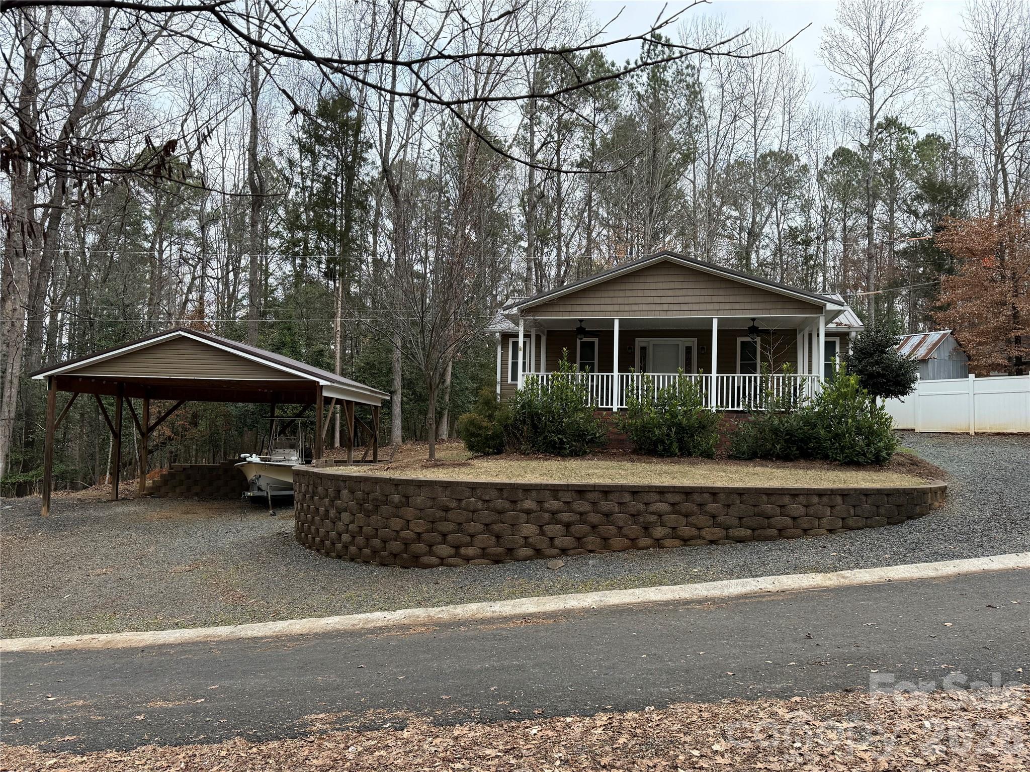 Welcome to one of the quietest location in Twin Harbor. This beautiful unit at the end of a cul-de-sac was completely updated, including a full brick foundation, full addition and covered front porch in 2017. Beautiful 3/4" real hardwood floors throughout. Ceramic tile in bathroom. 2 bedrooms with closets and an oversized bathroom with separate shower and large jacuzzi tub. Updated kitchen with quad door refrigerator/freezer, electric range and under mount sink. Plenty of cabinet and countertop space. The living room is a great size and includes nice furniture (all to remain). Sleeper couch, reclining loveseat and rocker recliner for you to enjoy. Great covered front porch with table, chairs and grill, all to remain. Perfect for your morning coffee or evening beverage. Plenty of parking on both sides of the house. A 24x24 covered boat shed was added in 2021. Large Keystone retaining wall with stairs to the boat shed. 8x10 wired building out back for additional storage. All furniture to remain. Come and see if this could be your "Happy Place" here in the park. All clients must be with realtor to gain access to the community. All clients and realtors must be signed in by owner or listing agent.