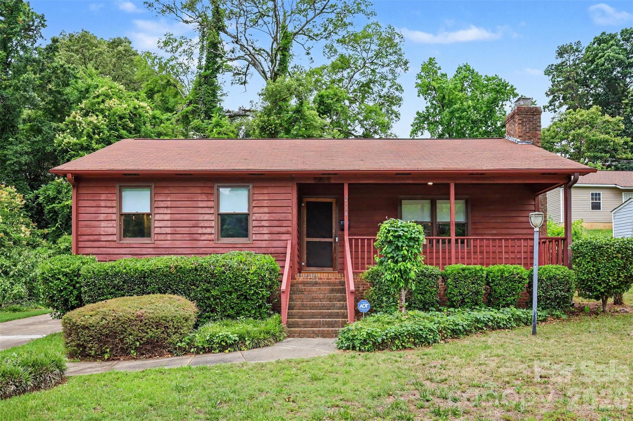 100% FINANCING AVAILABLE, NO HOA, + CUSTOM PATIO PACKAGE WITH FIRE PIT!!! Practically located in the heart of Charlotte, this 2 bedroom 2 bathroom home has been thoughtfully updated with one goal in mind...Entertaining. The show-stopping backyard sets this property apart from any other you will find, featuring a $50,000 custom stone patio with built-in fire pit, and unmatched privacy with trees surrounding the yard. The main living area features an open concept living space with LVP flooring and a beautiful floor to ceiling stone fireplace. The kitchen combines style and functionality with freshly installed granite countertops, a chef's sink, updated pendant lighting, ample cabinet space, and brand-new stainless-steel appliances. Down the hall you will find two large sized bedrooms, the primary bedroom features a double-door closet and an en-suite bathroom with an updated vanity, lighting, & walk-in shower. A generously sized second bedroom includes its own walk-in closet and is conveniently located near the second full bathroom.  For added peace of mind, major updates have already been completed, including a new roof (2023), HVAC system (2021), and water heater (2022). With abundant driveway parking (5+ spaces), No HOA, exceptional outdoor living, and a private setting…this is a rare opportunity to own a move-in-ready home just minutes from everything that makes living in Charlotte so great. Schedule your showing today!