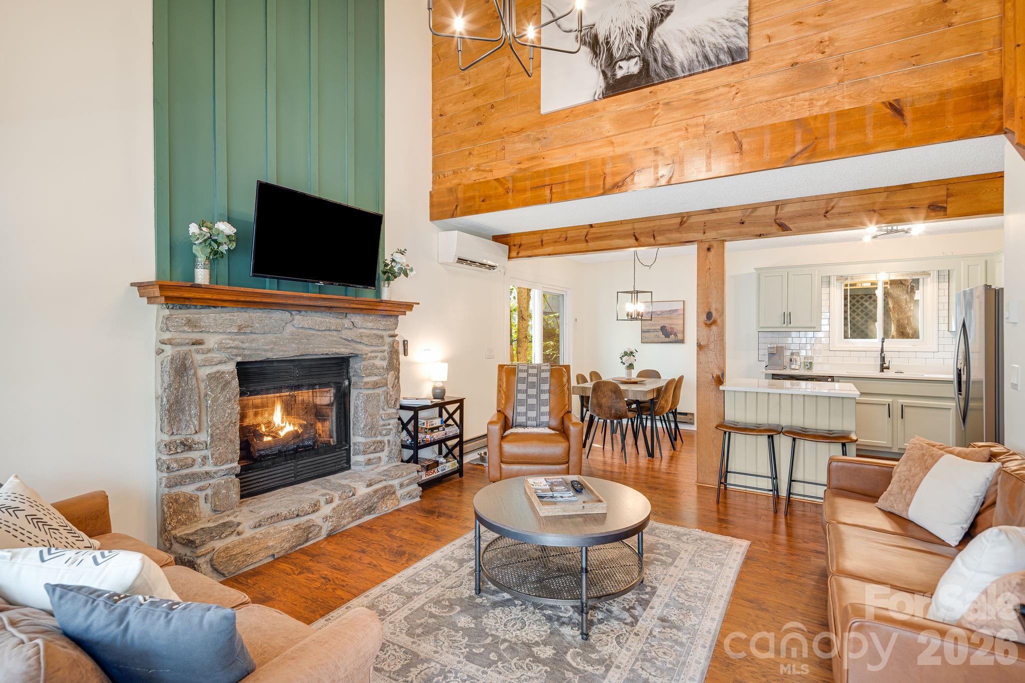 Gorgeous, updated mountain cottage located in the heart of Maggie Valley, offering charm, character, and a picturesque setting. Enjoy peaceful mountain living from the inviting front porch while listening to the soothing sounds of the mountain stream that runs along the side of the property.
The interior features a stunning two-story great room with a stone fireplace that opens to the breakfast nook and kitchen, creating a warm and welcoming space for gathering. Extensive interior updates throughout include accent walls, painted kitchen cabinets, white quartz countertops, large kitchen sink, stainless steel appliances, and beautifully updated bathrooms.
The home offers excellent outdoor living space—perfect for relaxing by the fire or enjoying games and entertaining. Conveniently connected to county water and sewer.
Ideally located near all the conveniences of Maggie Valley, Waynesville, Cataloochee Ski Area, and the Blue Ridge Parkway. This property is a prime opportunity and is currently a successful short-term rental. Being sold fully furnished, including all appliances, meticulously maintained - making it completely turnkey and move-in ready. Recent price repositioning enhances the value of this exceptional mountain home.