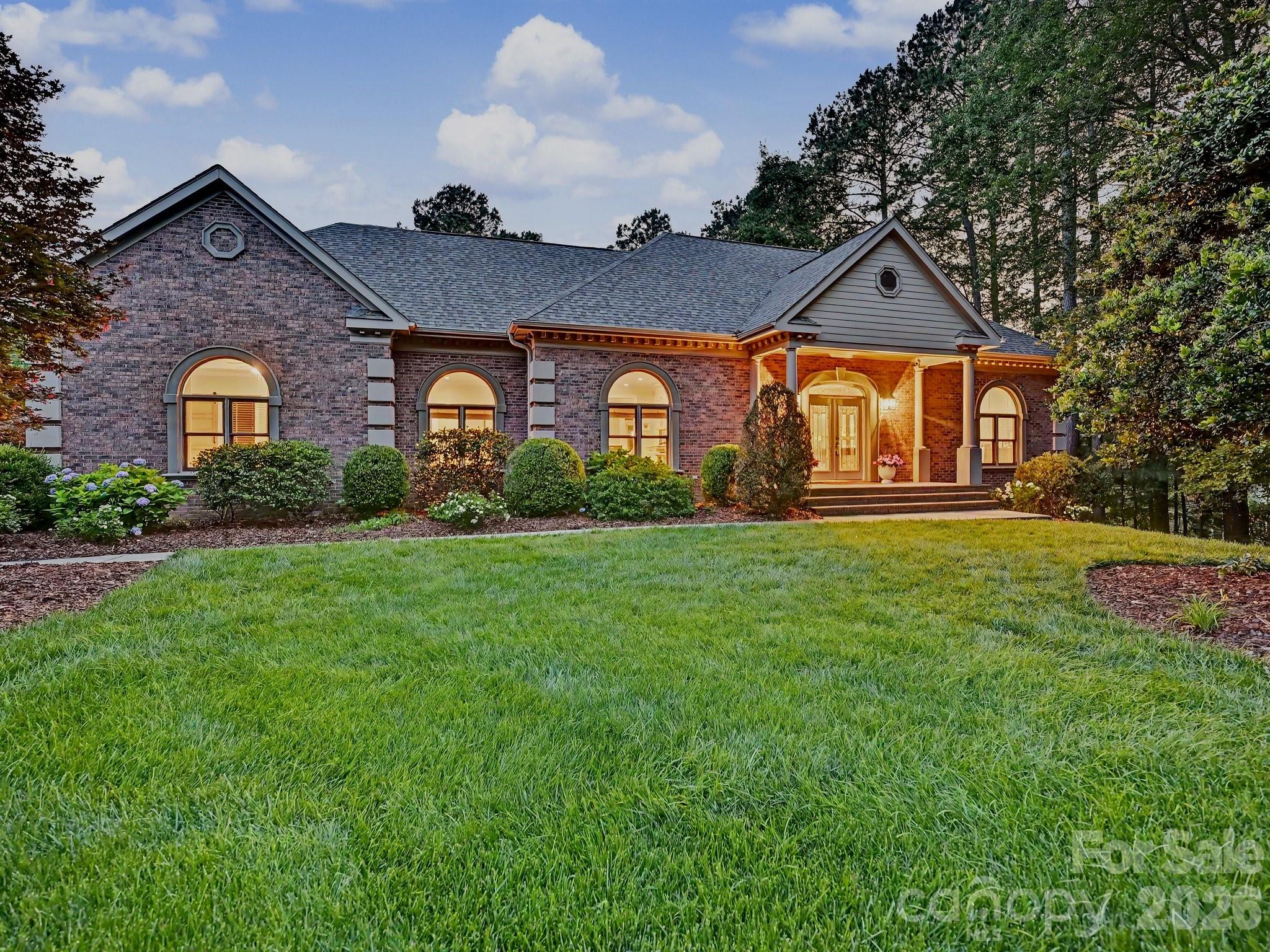 Renovated, refined, and ready to impress. This all-brick Weddington Hills home sits on nearly an acre and showcases craftsmanship and attention to detail at every turn. A covered front porch and gracious foyer introduce thoughtfully updated interiors designed for both everyday living and entertaining. 

The chef's kitchen is the heart of the home, outfitted with a paneled Sub-Zero refrigerator, Thermador 48-inch professional range with double ovens, Marvel beverage refrigerator, and a custom stainless vent hood, all framed by floor-to-ceiling cabinetry. A navy island with marble countertops and pendant lighting is the perfect gathering space, while an adjoining coffee and wine bar featuring cabinetry with pull-out shelving adds both function and style.

The main-level primary suite offers a quiet retreat with a tray ceiling and spa-like bath featuring a soaking tub, frameless glass-and-tile shower, dual quartz vanities, and a custom walk-in closet. 

The family room with gas log fireplace flows seamlessly into the dining room, both dressed with craftsman-style wainscoting, arched windows, and crown molding. Hardwood flooring extends throughout the main living areas. Three additional main-level bedrooms offer flexibility for guests, home offices, or fitness space, while the laundry room impresses in its own right with built-in cabinetry, Cambria quartz countertops, designer lighting, and a deep utility sink.

Upstairs, a spacious bonus/media room with French doors and cathedral ceiling is accompanied by a large bedroom and full bath, ideal for guests or recreation. 

Outside, an expansive covered porch offers multiple seating and dining areas overlooking a fenced backyard accented by newly planted mature trees, with seamless access to a paver patio and gas fire pit. 

Meticulously maintained and zoned for one of the area's most sought-after school districts with private walking trails maintained by the HOA to all three Weddington schools, this home delivers timeless design and modern luxury in equal measure.