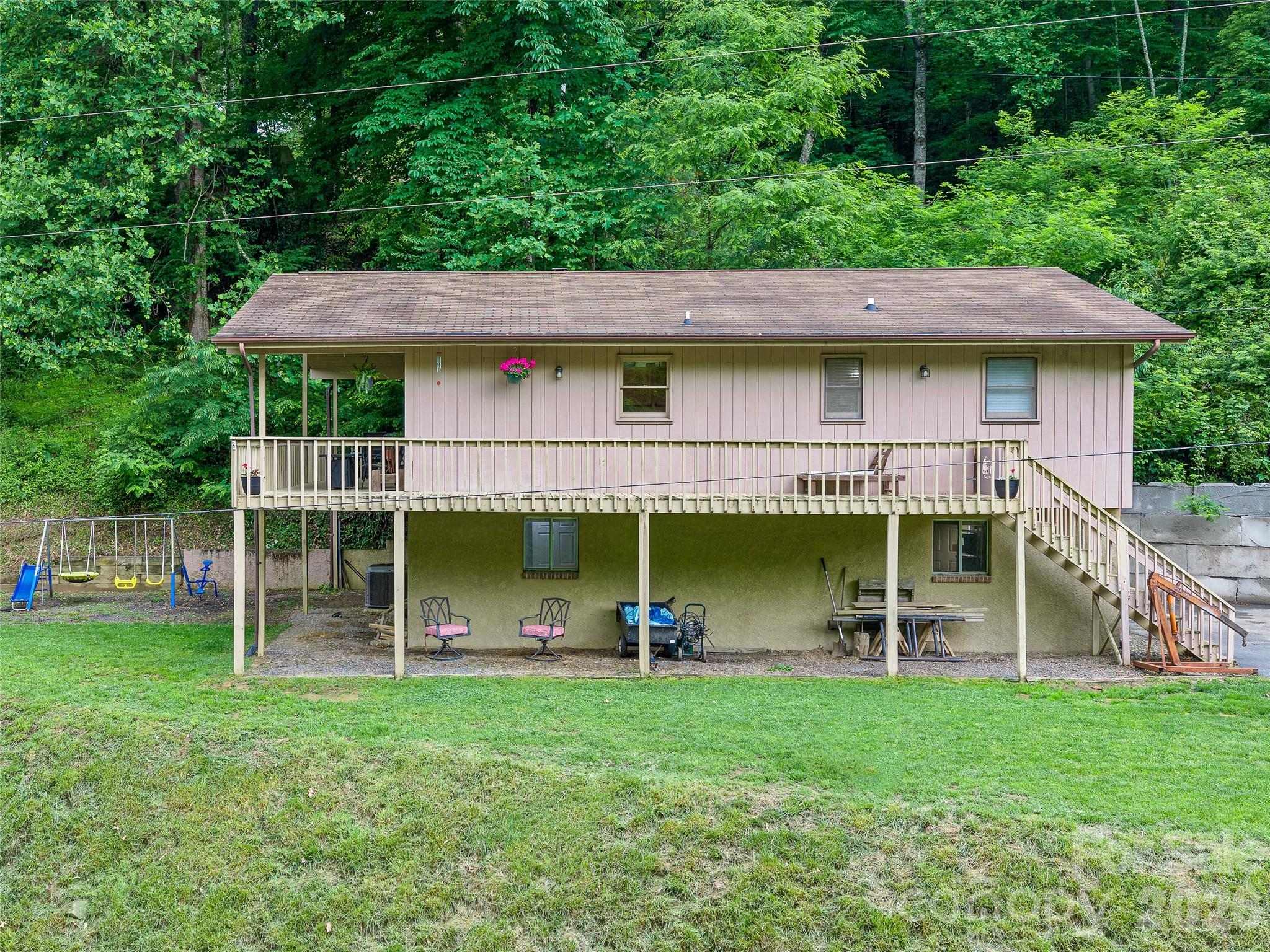 839 McKinney Road offers privacy, beautiful views, and a comfortable setting just outside of Burnsville. Situated on a mix of open yard and wooded surroundings, the property provides space to enjoy the outdoors while still being conveniently located near town. The home features 2 bedrooms, 2.5 bathrooms, and a newly added office space that works well for remote work, hobbies, or extra living space. The open floor plan creates an easy flow between the living, dining, and kitchen areas, while the fireplace adds warmth and character to the main living space. A basement and garage provide additional storage and workspace, and the outdoor areas offer plenty of room for gardening, entertaining, or simply enjoying the peaceful setting and scenic views.