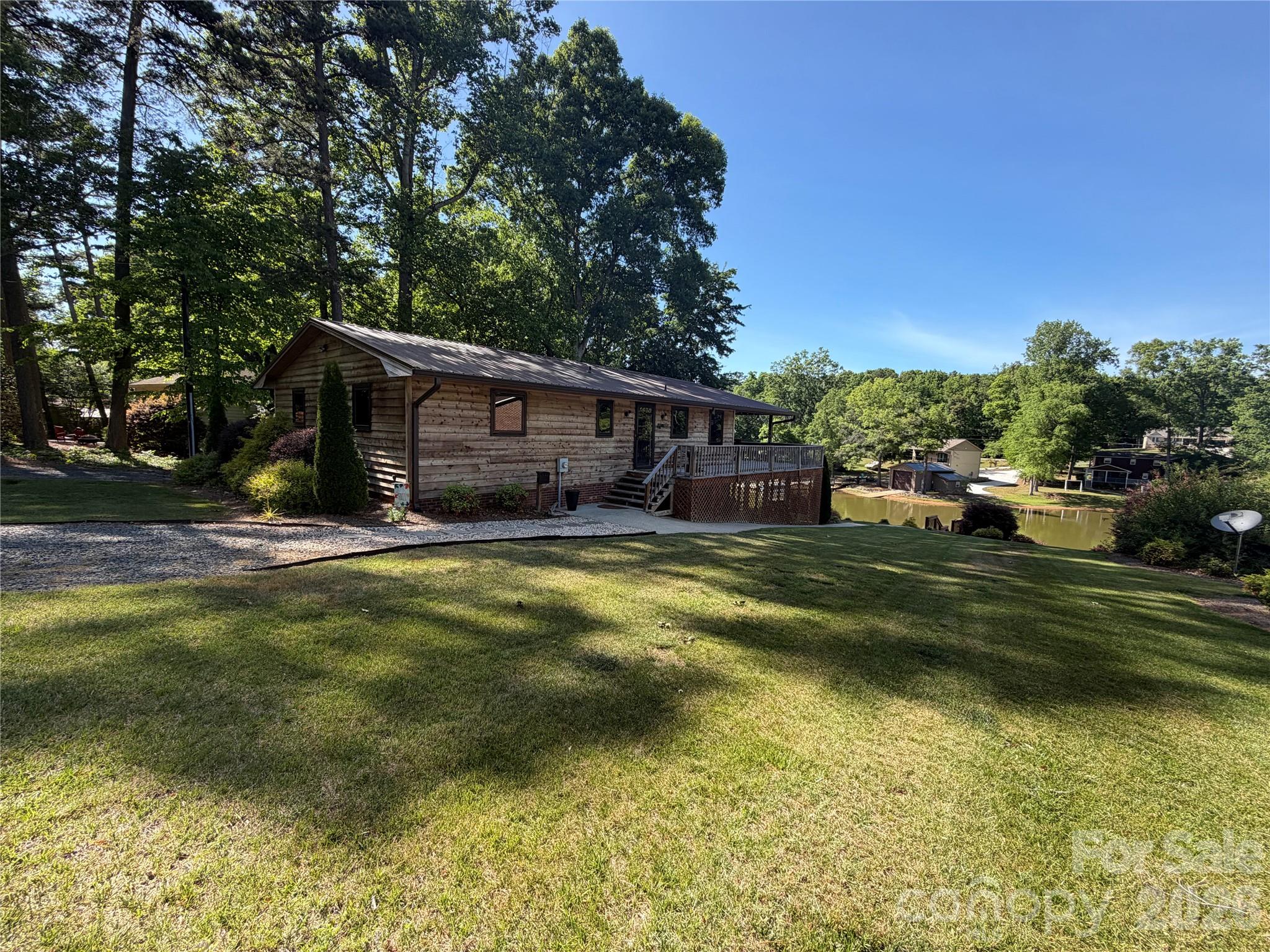 Welcome to 1438 Beckner Road, located on High Rock Lake. This waterfront home has been well maintained and has a floating dock & pier. This 2 bedroom, 2 bath home features screened in porch, partially covered deck with outside bar seating. Well manicured lawn & landscaping. Plenty of room outside for rest & relaxation. The home itself features a large master bedroom with master bath that has shower/tub combo. Wood burning fireplace in the living room. Kitchen comes with stove, microwave, dishwasher & refrigerator. Washer & Dryer is included and conveniently located on the main level. Basement is insulated and has concrete floor with a garage door. Plenty of parking for friends, family and guest. Just in time for Summer, this home you must see to appreciate. Schedule your showing today.