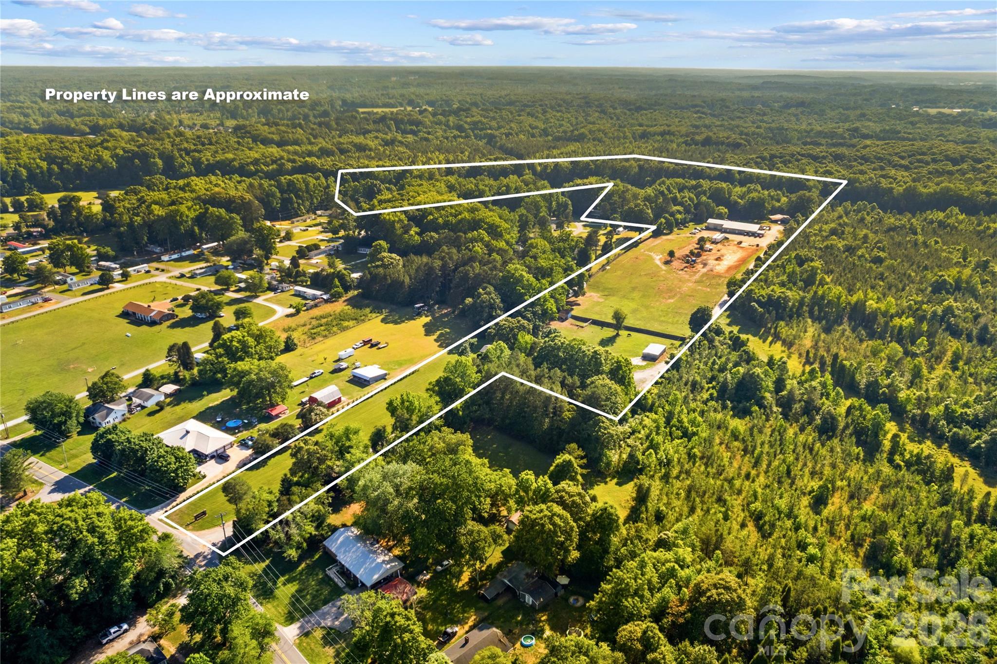 Discover the possibilities with this exceptional 20.91-acre property in Rowan County. Featuring an approximately 1,800-square-foot double-wide home, a massive 7,400-square-foot heated garage/shop with two heated/cooled office space and a private pond, this unique property is ready for its next owner.

Enjoy the peace and privacy of a secluded setting while remaining conveniently close to everything downtown Salisbury has to offer. Whether you're looking for a primary residence, a business location, or an investment opportunity, this property offers incredible flexibility, subject to applicable zoning requirements.  (Per Zoning this property can only be used as commercial space if the owner utilizes the property as a primary residence.)  Buyer to confirm with zoning before purchase if commercial use is applicable)

Perfect for business owners, developers, hobbyists, or anyone seeking quiet country living with room to grow. Opportunities like this are rare—don't miss your chance to make it yours.