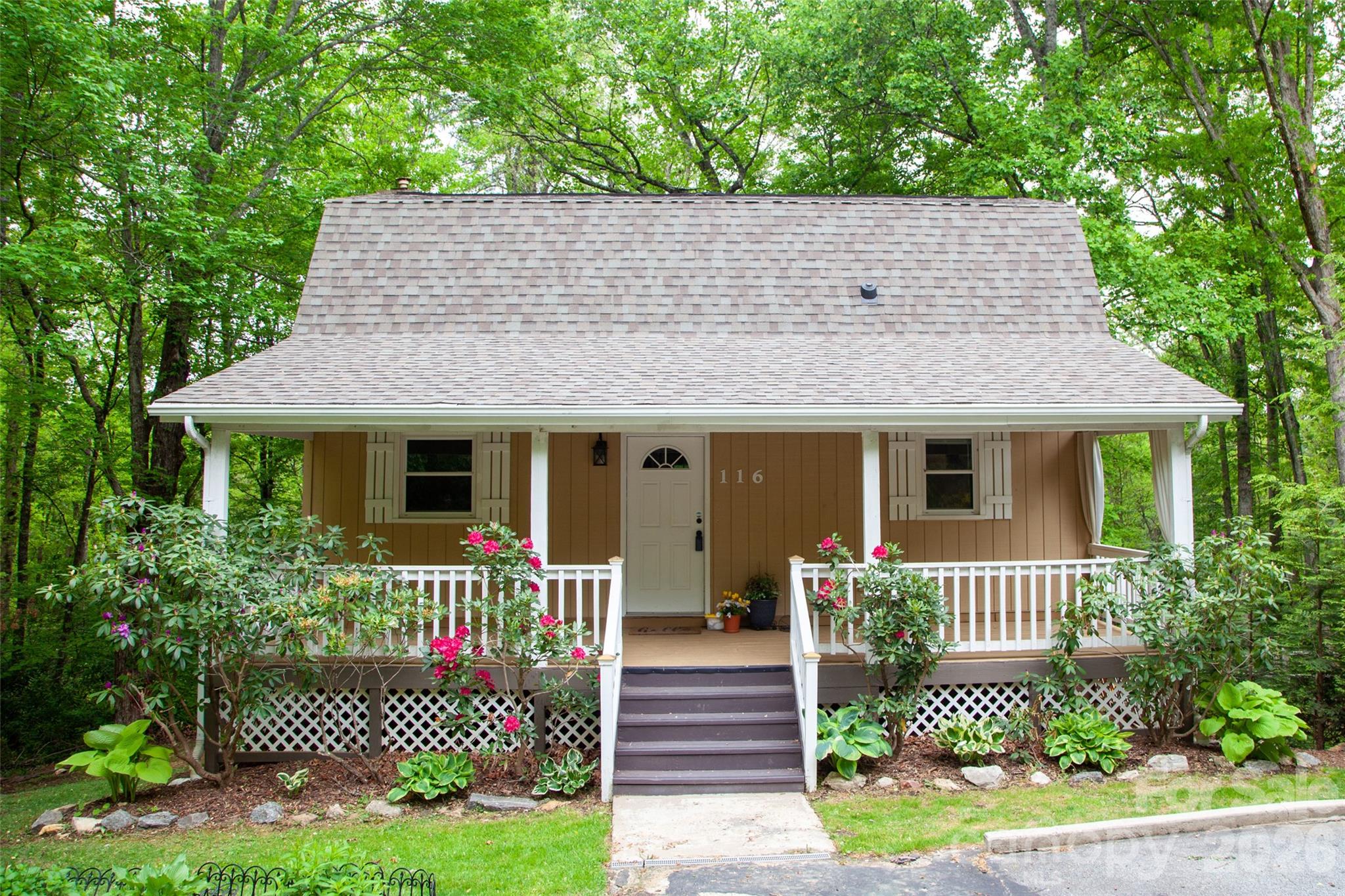 Step into a storybook mountain cottage where timeless charm meets endless possibilities. A large, welcoming front porch sets the tone, inviting you to slow down and soak in the peaceful surroundings. Inside, the main level features real hardwood floors, an updated kitchen, and a cozy fireplace—perfect for cool mountain evenings.  Downstairs, a fully equipped rental unit offers its own fireplace, kitchenette, and laundry, for income potential or in-law suite.  Situated on a lush, wooded lot, the outdoor space is just as magical with a fire pit ideal for gathering under the stars. Adding even more versatility, an approximately 350 sq ft studio/workshop is ready for finishing, with electricity, propane heat, and concrete floors already in place—perfect for an artist’s studio, home office, or creative retreat. Whether you envision a multi-generational home, a primary residence with rental income, or a true mountain getaway, this property delivers. All of this in a premier mountain setting, less than 20 minutes to Asheville—your dream escape tucked away in nature.