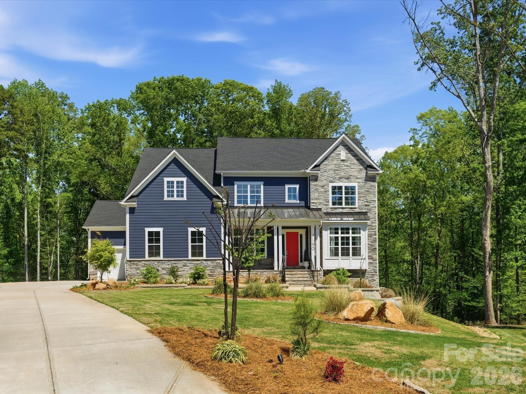 This is your dream backyard! Situated at the end of a cul-de-sac in one of Fort Mill’s most sought-after communities, this 1.72-acre property offers a fully fenced backyard surrounded by mature trees with a heated pool and spa and an abundance of yard. This beautiful home offers over 5,300 square feet with a finished, walk out basement. Formal dining perfect for entertaining/holidays, a separate dedicated office space and a main level guest ensuite that has access to their own laundry. Tons of natural light throughout. Great room with custom built-ins is open to beautiful white kitchen featuring quartz surfaces, gas cooktop, wall oven and breakfast that opens to screen porch. Upstairs, the primary suite is generously sized and features a relaxing bath retreat with new quartz counters, large walk in shower, soaking tub, and ample closet space. The secondary bedrooms are well laid out, including a Jack and Jill bath, an additional ensuite bedroom, and huge bonus. The upstairs laundry room includes custom built-ins and a utility sink. The finished basement expands the home with a large recreation space, kitchenette, storage, and a flex room currently used as a gym but could be 6th bedroom. This home's floorplan offers several options for extended stays or multi-generational living. Homes with this combination of lot size, setting, and livability are hard to find!