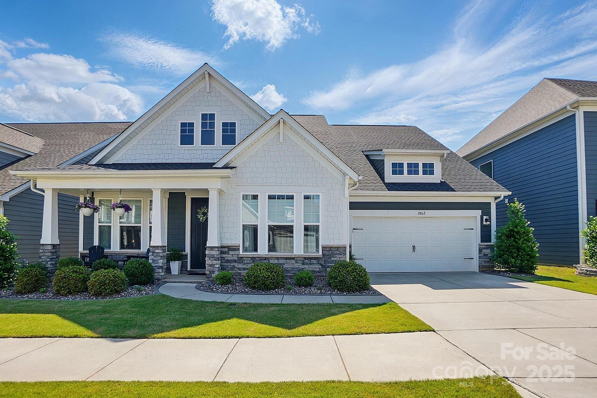 Welcome to 2062 Nellies Way, a beautiful, better than new home nestled in one of Fort Mill’s most sought-after communities. Built new in 2021, this spacious 4 bed home features an open-concept layout with abundant natural light, modern finishes, and thoughtful design throughout. The kitchen boasts sleek countertops, ample cabinetry, and flows seamlessly into the living areas. Main floor primary suite with a walk-in closet features a huge dual vanity, frameless glass shower and soaker tub! Bonus living area upstairs makes for the ultimate play room or hangout space! Step outside to a private backyard ideal for relaxing or hosting friends and family. What truly sets this home apart is the resort-style community amenities: take a dip in the sparkling pool, float your worries away in the lazy river, or spend afternoons enjoying nearby parks and trails. Located just minutes from top-rated Fort Mill schools, shopping, dining, this home offers comfort, convenience, and community all in one!