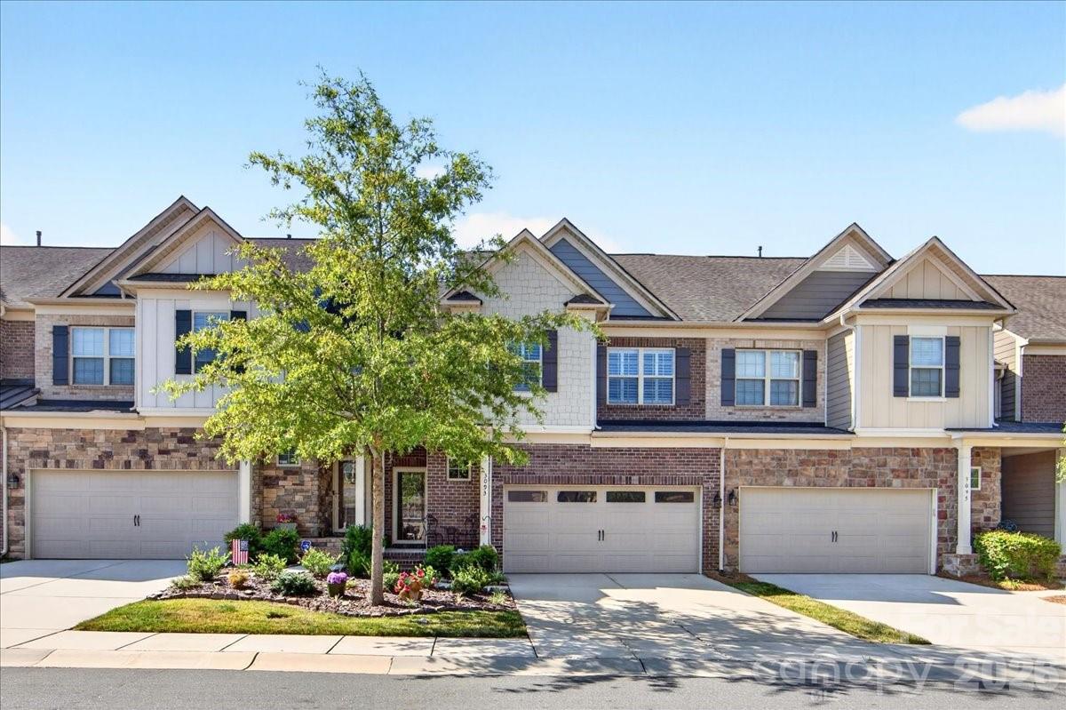 **Welcome home to this beautifully updated townhome in Fort Mill's highly sought-after Bridgemill community!**

Offering 4 bedrooms, 3.5 bathrooms, and an impressive 2,922 square feet,  this is one of the community's larger floor plans and one of only 10 homes featuring a fully finished walkout basement.

The thoughtfully renovated lower level is ideal for multi-generational living, guests, or entertaining, complete with a bedroom, full bath, kitchenette, living and dining areas, plus direct access to a private patio with a custom-built fire pit.

Inside, the welcoming foyer opens to a spacious, light-filled floor plan featuring an expansive living and dining area and a beautifully updated kitchen with quartz countertops, stainless steel appliances, custom cabinetry, and a walk-in pantry with built-in storage.

Just off the dining area, the bright sunroom leads to a brand-new covered deck (2025)with stairs and a landing for easy access to the backyard and patio—perfect for outdoor dining, relaxing, or enjoying your morning coffee.

Upstairs, the spacious primary suite offers a luxurious ensuite bath and a custom-designed walk-in closet that is sure to impress. Two additional bedrooms and a full bath provide plenty of room for family, guests, or a home office. Large 394 SF two car garage is another bonus. 

This exceptional home offers the rare combination of generous living space, extensive updates, and versatile living options. Residents of Bridgemill enjoy outstanding amenities including two community pools, pickleball/tennis courts, recreation area, scenic walking trails around a 3.5 acre pond, and beautifully maintained common areas, all just minutes from shopping, dining, entertainment, and convenient access to both Fort Mill and Charlotte.