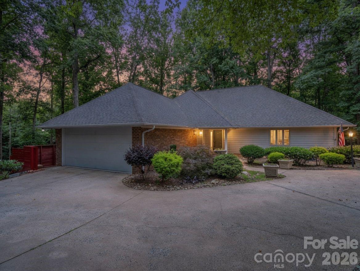 Welcome to Country Club Gardens, a beautiful in town neighborhood with nice homes on large lots and wide streets great for walking and bike riding, and street lights at night. Very convenient to plenty of shopping, restaurants and various businesses. Access to walking trails a couple blocks from this home. A circular driveway takes you to the home set back from the road with plenty of parking and 2 car garage on the main level. The entry opens up to a large sunken living room with built-ins and a gas log fireplace and flows into the dining room. Beautiful wood floors in entry, hall, kitchen and dining room. A guest bedroom, half bath and coat closet are off the entry hall and spacious primary bedroom in back with a large walk-in closet, built-in makeup counter, and en-suite bathroom with double vanity and large tile walk-in shower. Large kitchen with granite countertops, stainless appliances, huge center island with breakfast bar, plenty of cabinets for storage and breakfast area. Pantry closet, broom closet plus large walk-in pantry closet with lots of shelves freshly painted. Spacious laundry room, washer and dryer included, in between the kitchen and garage. Enjoy the peaceful back yard and wildlife sitting out on your wrap around deck partially covered from the living room and open around the side of the house with a door to the kitchen, and stairs to the ground level. Very large fenced in back and side yard with trees. A creek runs behind and outside the fenced yard (not on this property). The lower level has a large family room with a gas log fireplace, beverage/wine refrigerator and exterior door to the covered patio and back yard. Two more bedrooms with a Jack & Jill bathroom in between them, each with their own vanity/sink, one has a large walk-in closet and the other has 2 large closets. That downstairs hall goes through a small bonus room and into the spacious unfinished workshop, 1 car garage and large storage room. This is a wonderful home for entertaining, a large family or plenty of room for overnight guests.  Since their purchase, they replaced several windows, new carpet in the main living room and primary bedroom, a lot of interior paint, painted the entire deck, other misc. and added plenty of nice landscaping. The gutters were cleaned and the roof soft washed on 06/03.