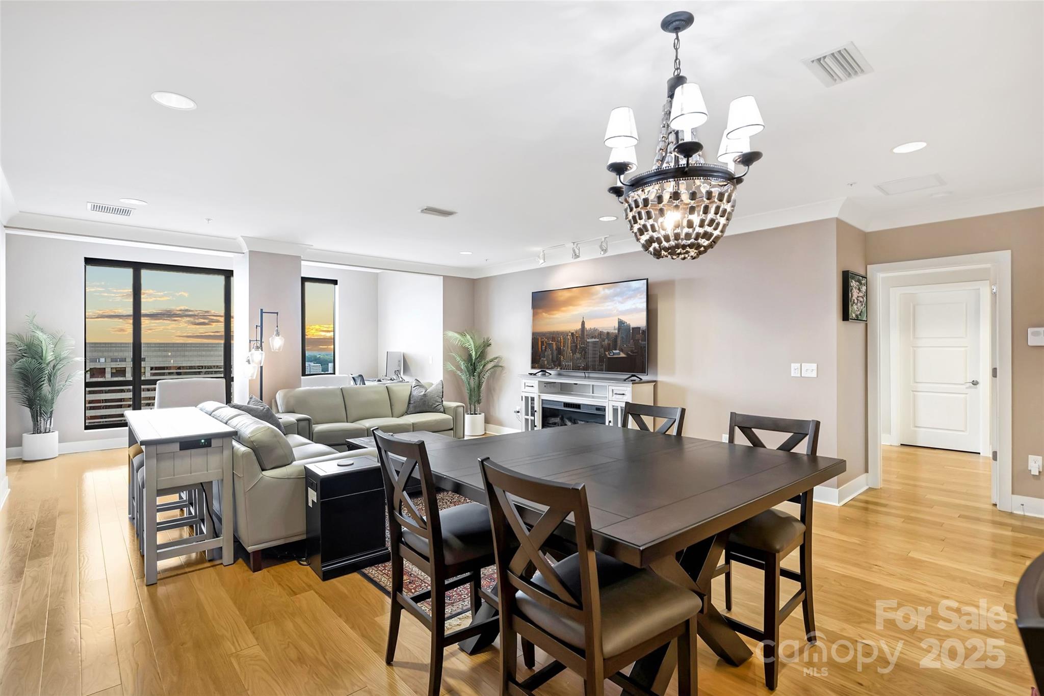 Perched on the 18th floor, Residence 1812 offers stunning views and luxurious updates throughout. From the moment you step inside, you’ll be impressed by the attention to detail—rich wood flooring flows throughout the home, paired with sleek, modern crown molding for a clean and contemporary look. The chef’s kitchen is a standout, featuring an upgraded appliance package with a gas cooktop, slow-close cabinetry, and stylish lighting. Both bathrooms and bedrooms continue the elevated design, with California Closet systems.The expansive open-concept living area is perfect for entertaining or relaxing. Enjoy the sunroom—ideal as a cozy retreat or home office, plus a covered terrace, the perfect place to take in the sunrise. Retreat to the oversized primary suite, complete with tray ceilings and its own private terrace. Enjoy concierge service, private theatre room, resident lounge, fitness center, and an incredible rooftop restaurant with sweeping skyline views!