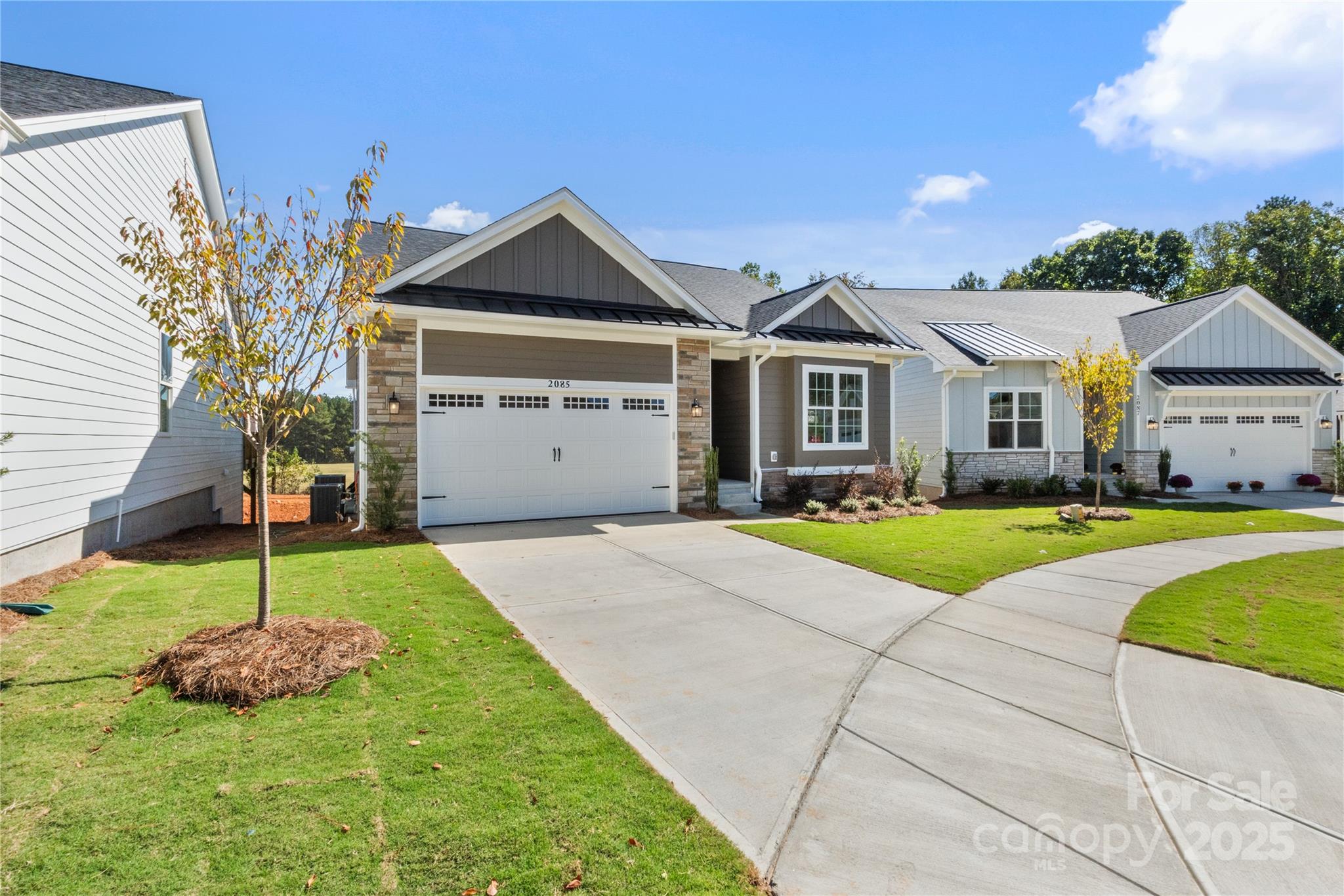 Welcome to this beautifully designed ranch home in one of Fort Mill’s premier 55+ communities, offering sweeping views of the golf course driving range from both the great room and the primary suite. Only one owner must be 55+, providing flexibility for multi-generational living.
The open-concept layout features a gourmet kitchen with generous prep space, a cozy gas fireplace, and seamless access to a large covered deck — the perfect setting for morning coffee or evening sunsets overlooking the green.
The main level includes a spacious primary suite with golf course views, a guest bedroom, dedicated home office, and convenient laundry room.
The fully finished walkout basement expands the living space with a large recreation room, fourth bedroom, additional laundry area, and kitchenette — ideal for a true mother-daughter arrangement or extended guest quarters. A versatile flex room easily accommodates a golf simulator, home gym, media room, or private den. Abundant storage throughout enhances everyday functionality.
Situated on a quiet cul-de-sac, the home also offers a two-car garage with pull-down attic access, professionally landscaped yard with irrigation, and HOA-covered lawn maintenance for easy, low-maintenance living.
Enjoy close proximity to downtown Fort Mill, dining, shopping, the golf club, and Walter Elisha Park — all within a peaceful golf course setting.

A rare opportunity to enjoy space, flexibility, and views in a sought-after active adult community.