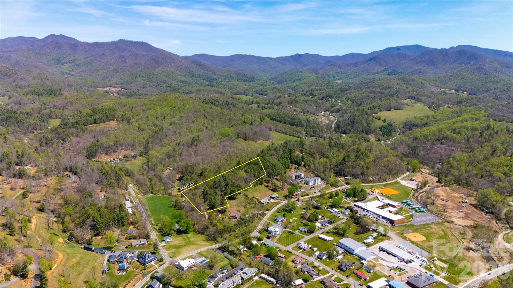 Imagine waking up to sweeping mountain views overlooking the charming small town of Bakersville, North Carolina—the artistic heart and county seat of Mitchell County. This rare 5.517-acre parcel sits in a vibrant community where artists thrive, galleries flourish, and creative energy fills the air. With easy access, city water available at the road, no deed restrictions, and no HOA fees, the possibilities are as wide-open as the vistas before you. Build your dream mountain home, create a private estate, develop vacation rentals, or design a multi-family retreat—the door of opportunity stands wide open here. You're at the gateway to Roan Mountain, with its world-famous rhododendron gardens, iconic grassy balds, and some of the most breathtaking sections of the Appalachian Trail. Endless hiking, panoramic summits, and cool high-elevation adventures await just minutes away. Down below, the crystal-clear Toe River offers world-class trout fishing, thrilling whitewater rafting and kayaking, or peaceful swims on hot summer days. This is mountain living at its finest—peaceful, unrestricted, and inspired by nature and artistry. Don't let this rare opportunity slip away.  Ready to claim your slice of the Blue Ridge? Contact us today to schedule a private showing and start turning your mountain dreams into reality.