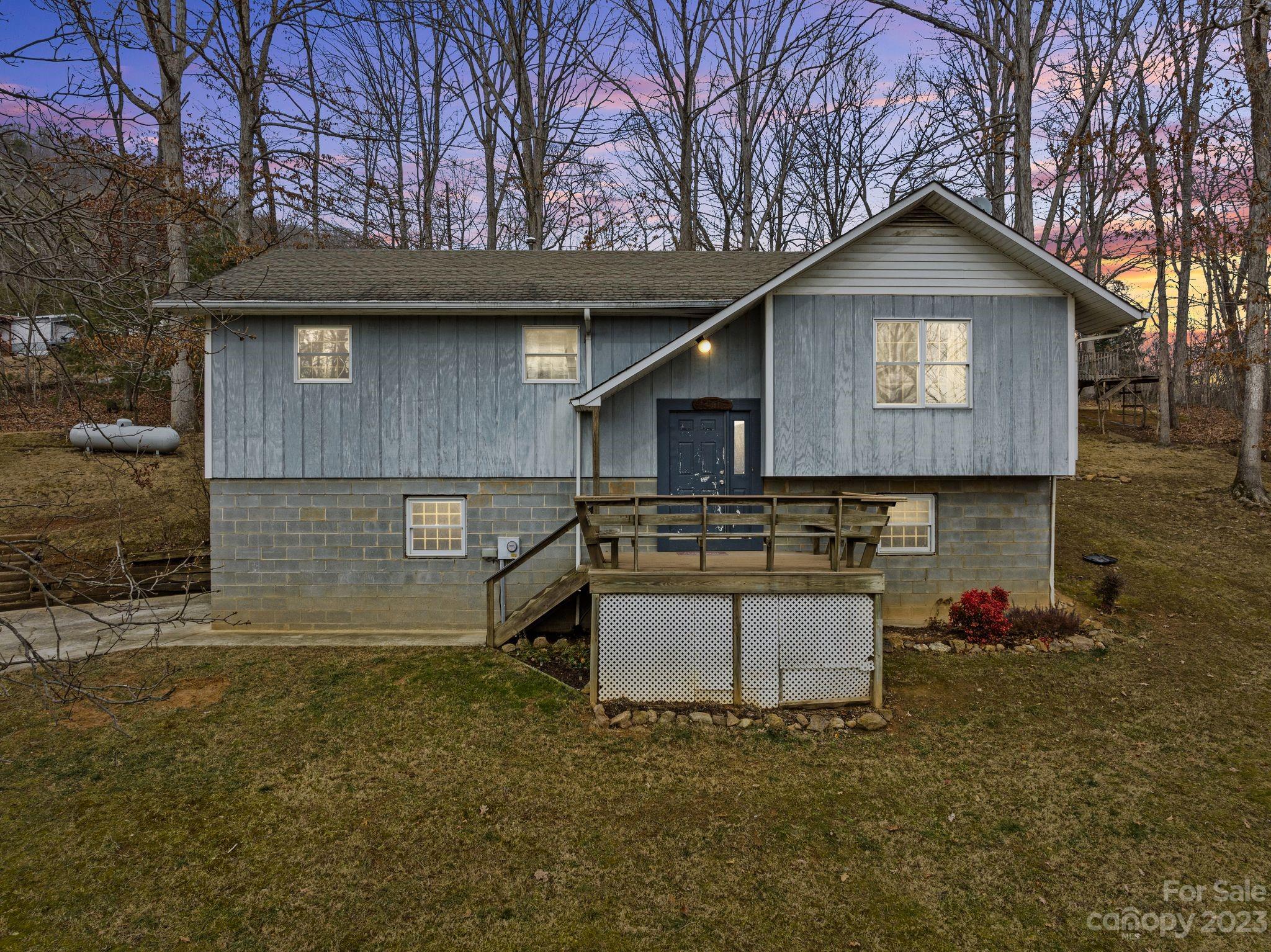 Nestled on a picturesque 2-acre lot in Clyde, NC, this charming 3-bdrm, 2-bth home seamlessly blends comfort, style, & convenience. Step into a bright & airy space, where the open floor plan unites the dining & kitchen areas, perfect for gatherings. The spacious eat-in kitchen is a standout, equipped w/ stainless steel appliances, ample counters, & cabinets w/ a soft pop of color, adding elegance. The finished basement offers a cozy retreat w/ a fireplace, ideal for relaxation or entertainment. Outside you will enjoy a spacious deck overlooking the sprawling backyard, great for barbecues or enjoying serene natural surroundings. With a thoughtful layout & tasteful finishes, this home provides a tranquil, modern living experience in scenic Clyde. Embrace this slice of North Carolina's charm, where each day feels like a getaway.