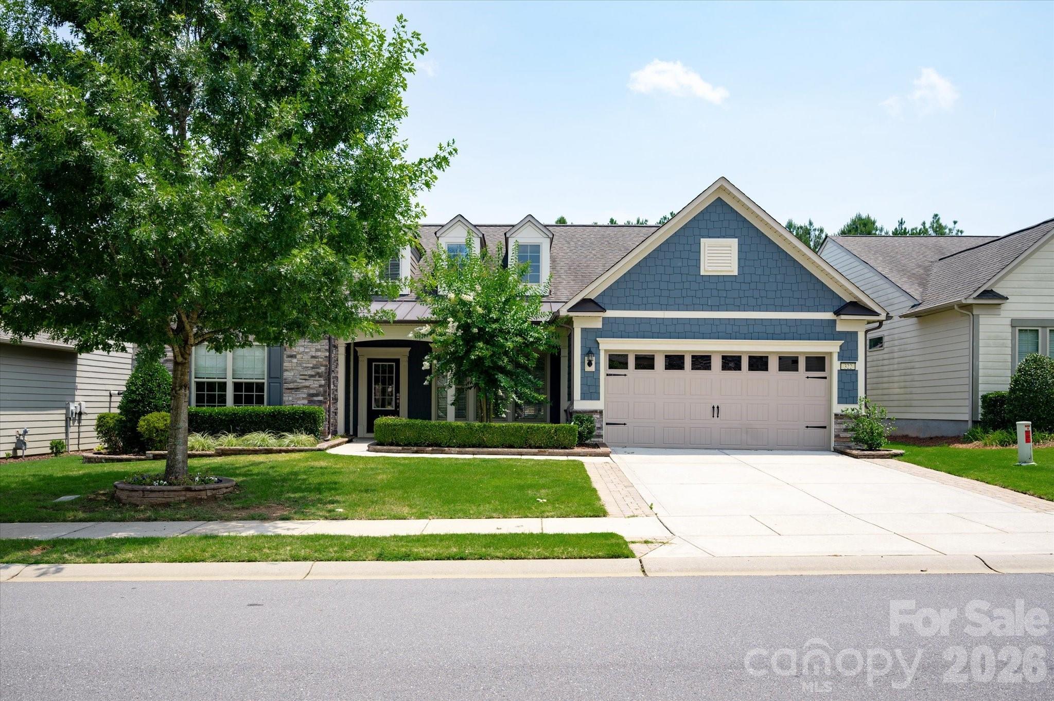 Popular Tangerly Oak model offering exceptional space on one of the community's most desirable homesites. Relax on the screened porch, sunroom or patio while enjoying peaceful views of acres of common area, creating a private, serene backyard setting. The beautiful white kitchen features granite countertops, soft-close cabinetry, a glass cooktop, direct-vent hood, and abundant workspace. The flexible split-bedroom floor plan on the main level offers privacy and can function as dual primary suites, while a private office provides the perfect work space. Additional upgrades include a walk-in shower in the primary bath, radiant barrier roof sheathing, tankless water heater, brick front exterior, and an extended garage ideal for a golf cart or additional storage. Upstairs, you'll find an oversized loft, a spacious guest bedroom with full bath, and generous walk-in storage. Enjoy resort-style amenities including a clubhouse, fitness center, ballroom, meeting rooms, indoor and outdoor pools and hot tubs, dog park, grandkids' playground,  lighted pickleball courts, lighted tennis courts, bocce courts, an aerobics studio, a full-time activities director, and countless clubs and social activities.