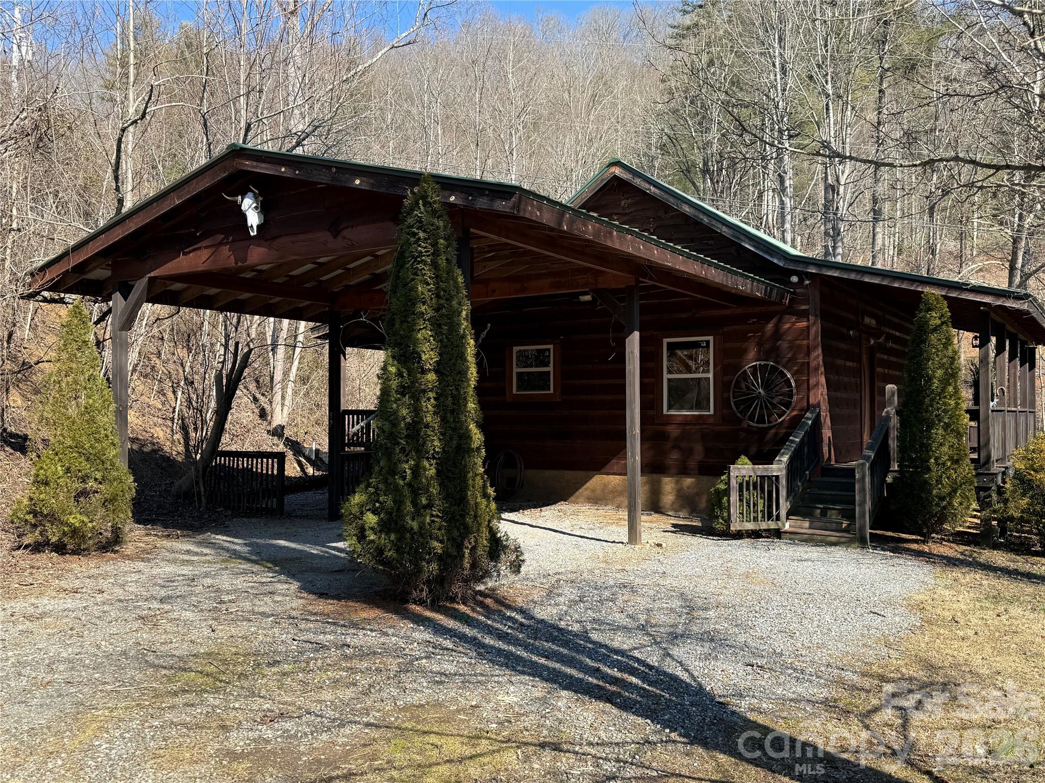 Discover mountain living at its best at 52 Supooh Lane in beautiful Sylva, North Carolina. Tucked into a quiet setting with year-round natural beauty, this home blends privacy, comfort, convenience, and affordability in the Savannah Community of Jackson County. The property features an inviting open-concept layout, warm wood finishes, and thoughtful updates throughout. Step outside to enjoy the best of mountain life. A large, covered deck overlooks the amazing Smoky Mountains creating a serene outdoor space ideal for morning coffee, evening gatherings, or simply unwinding. The gently sloping lot offers usable yard space while maintaining the privacy of a wooded backdrop, just a short walk to Savannah Community Park, with a pet walking trail, restrooms, kids' playground, and a large picnic shed. Located just minutes from downtown Sylva, Western Carolina University, Franklin, Cullowhee, shopping, dining, and outdoor recreation, this home offers the perfect balance of seclusion and accessibility. Whether you’re seeking a full-time residence, mountain getaway, or investment opportunity, 52 Supooh Lane delivers comfort and charm in a truly special setting.