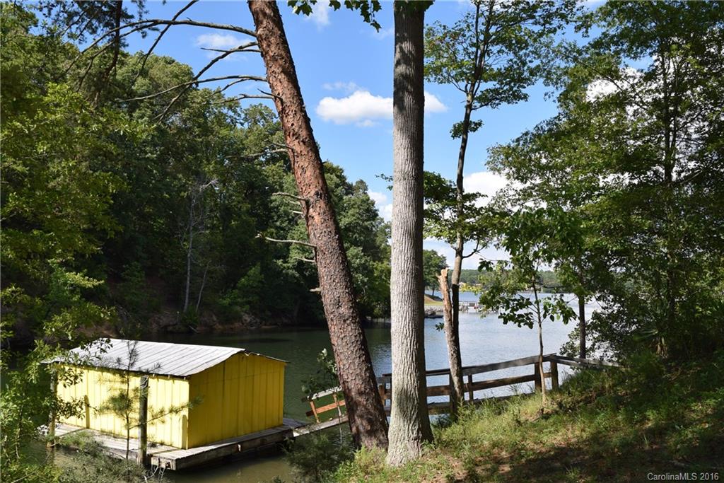 What an excellent opportunity on Lake Wylie! Choice 1 acr lot with over 350' shoreline & gorgeous hardwood trees, nestled among fine custom waterfront homes in excellent Clover school distr. Property located on a short cove, perfect for swimming and paddling around, with quick access to open water for boating and water sports. Boathouse with floating dock, plus mobile home currently on property to enjoy until you're ready to build.  Great location, great value! Also listed as land MLS #3207431