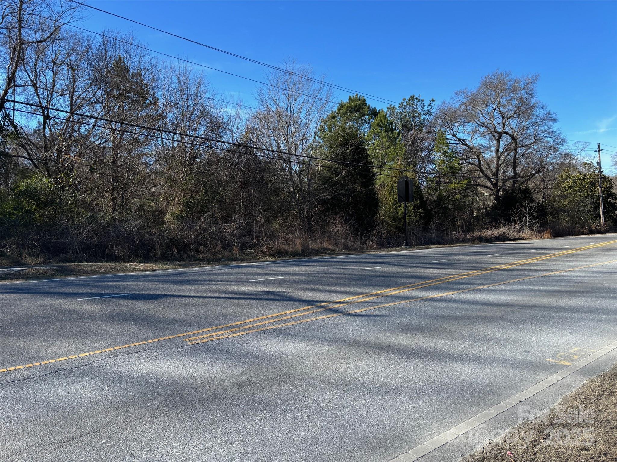 Attention Builders! Put a few homes on this property. This property has 229 feet of road frontage on Mountain Island Hwy. Perfect location to build that dream home conveniently located in Mount Holly,  being so convenient to Gastonia, Belmont, Charlotte, Denver, only mins away from Charlotte Airport, Downtown Charlotte, White Water Center. City water accessible.