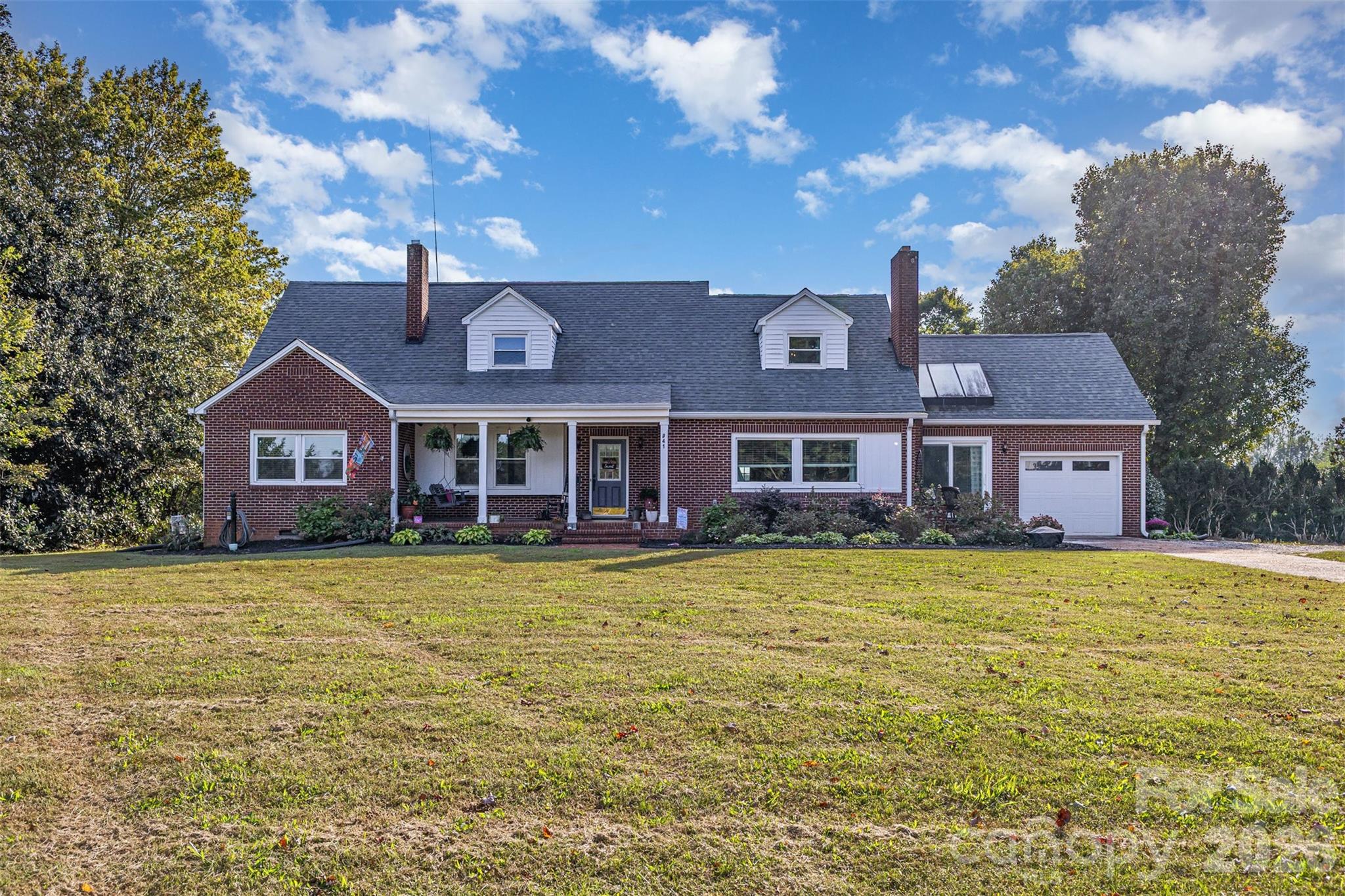 Set on over 10 acres of open, rolling countryside, this remarkable property offers a rare blend of space, functionality, and rural charm. The land itself is a major asset, featuring an **active hay field** and cleared, usable acreage with scenic views in every direction. It is an ideal setup for those seeking a true country lifestyle, complete with a **dedicated well for feeding livestock** and a functional barn ready for agricultural or equestrian use.

The main home welcomes you with classic character, warm living spaces, and ultimate peace of mind courtesy of extensive, high-value upgrades. The exterior features a new roof on both the house and the detached garage (2017), new gutters (2020), a professionally lifted and stabilized front porch (2021—still under warranty), and the home is **whole-house generator ready**. Inside, large new windows (2020—still under warranty) flood the home with natural light and frame beautiful views of the surrounding acreage.

The main floor plan offers an excellent mix of open and defined spaces, highlighted by a fully gutted and remodeled kitchen (2022) featuring modern, upgraded appliances. Year-round comfort is guaranteed across all levels with a new upstairs HVAC system replaced in 2024. The home’s accommodations are equally impressive, featuring an upstairs bathroom and a main-level bathroom that were both beautifully gutted and completely remodeled in 2025. Spacious Sunroom on main floor makes for an excellent game room or sitting room to soak in the natural light. Upstairs, you will find a versatile **fourth bedroom that makes a perfect home office** or flex space.

A standout feature of the property is the detached garage, complete with a workshop and a fully equipped second living quarters above. Offering its own bedroom, full bath, kitchen, and living space, this setup provides excellent flexibility for guests, extended family, or potential rental income. For additional space, the full walk-out basement presents a blank canvas with significant square footage. It was completely dried-in with French drains and a sump pump installed (2021—still under warranty), making it ready for storage, a workshop, or future custom expansion.

Outdoors, the property truly shines as an entertainment haven. Enjoy the fresh air from the newly added screened-in back porch (2025), fire up the grill on the large deck (2021), or cool off in the above-ground pool. Complete with a newer hot water heater (2022/2023), this is a unique opportunity to own a meticulously maintained, versatile property where acreage, infrastructure, and modern updates come together perfectly.

$5,000 being offered to be used at buyer's discretion.