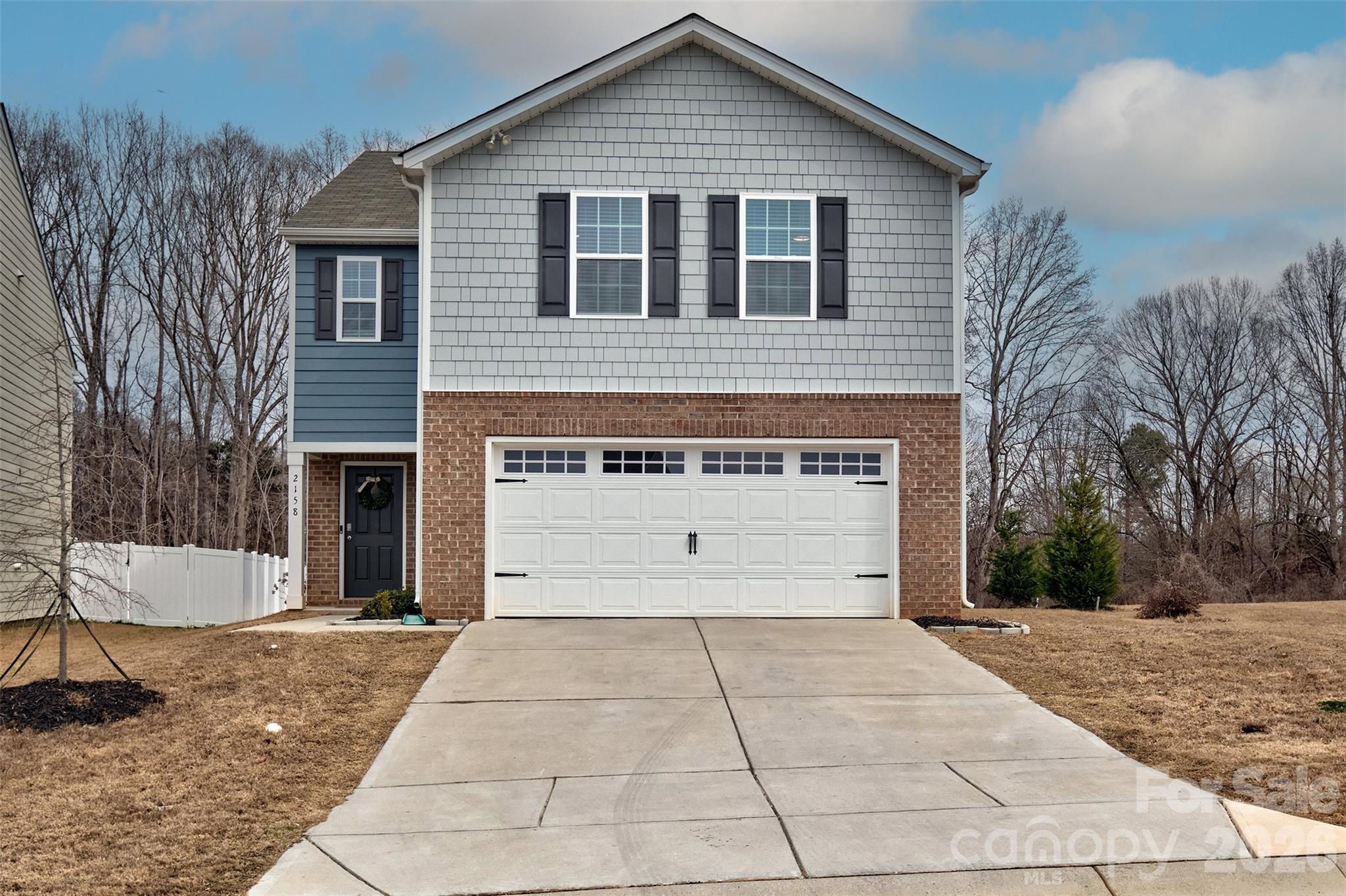 This like-new home offers the space and functionality you’ve been looking for! The open-concept layout is perfect for everyday living and entertaining, highlighted by a beautiful kitchen with a large island, granite countertops, white cabinetry, stainless steel appliances, and gas cooking. The bright and airy family room features a cozy gas fireplace and abundant natural light, flowing seamlessly into a generous dining area that easily fits a full-sized table for gatherings. Upstairs, you’ll find a versatile loft space — ideal for a home office, playroom, workout area, or second living space. The spacious primary suite includes an oversized walk-in closet, and you’ll appreciate the impressive amount of storage throughout the home. Step outside to a flat backyard with trees along the rear for added privacy. Conveniently located near Lake Wylie and downtown York, this home combines comfort, style, and a fantastic location.