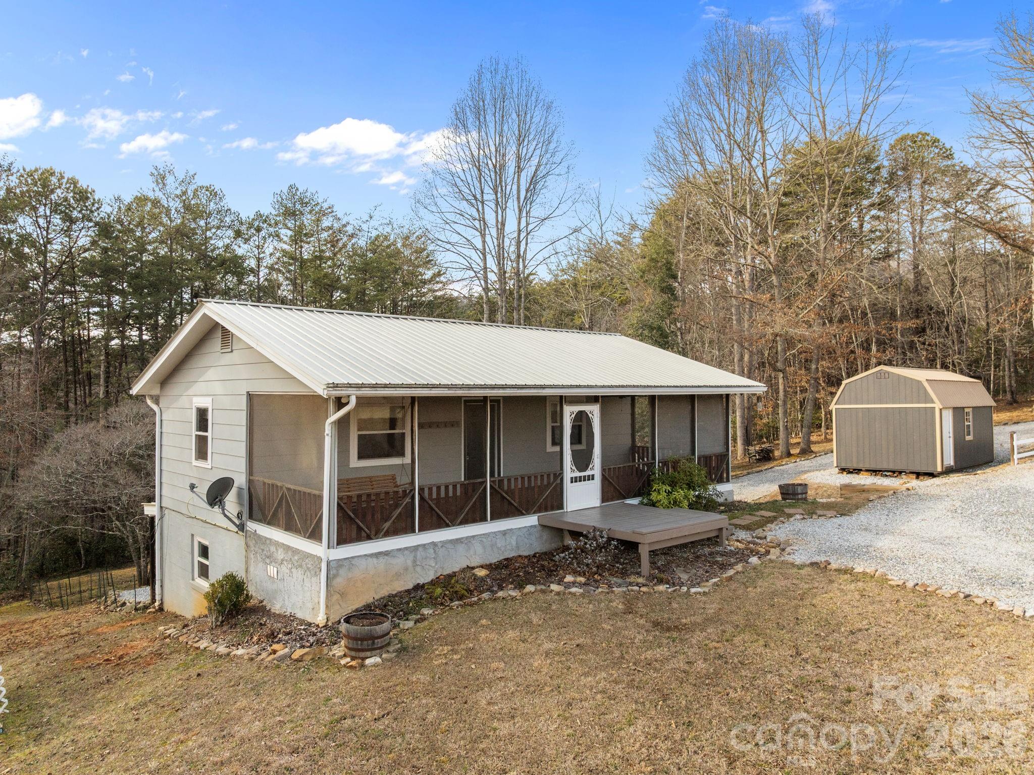 Rare opportunity to own a beautifully maintained, move-in ready cottage in the highly sought-after Cowee area of Franklin, offering 2.4± acres of gently rolling usable land, mountain views, pastoral scenery, and the flexibility today’s buyers are searching for. Ideal for gardening, outdoor recreation, homesteading, or mini-farm potential, this property offers a unique blend of privacy, functionality, and easy mountain living.
The spacious screened-in porch creates the perfect place to relax and take in the peaceful surroundings, while the home’s open-concept upper level provides comfortable everyday living with natural flow for gathering and entertaining. Two private lower-level bedrooms offer a practical layout for guests, full-time living, or a mountain retreat setup.
A valuable added feature, the property includes RV hookup, creating extra flexibility for travel, visitors, or additional utility options rarely found in this price range. Located just minutes from downtown Franklin, shopping, dining, and outdoor recreation, this home offers the increasingly hard-to-find combination of usable acreage, convenient access, and peaceful country setting.
Whether you are searching for a full-time residence, weekend escape, or investment opportunity, this Cowee property stands out for its land, versatility, and lifestyle appeal.