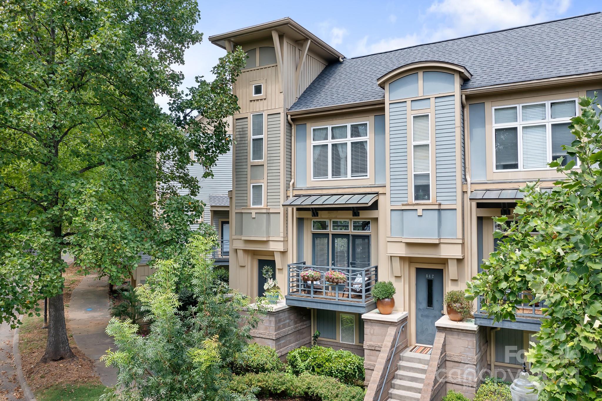 Beautiful 2 bedroom end unit in the desirable First Ward in Uptown! Open floor plan. Wide plank hardwoods in main living areas. Kitchen offers granite & tile backsplash. Living Room w fan & surround sound. Each bedroom features a private bath & generous closet space. Lower level leads to a private enclosed outdoor patio, with a pergola and lighting giving that perfect ambience for time with family and friends. Upper level terrace overlooks the skyline, with views of the city in the winter months. Fridge, tv, washer & dryer convey. Unit steps from the community mailboxes. Great schools. Short walk to TWC Arena, 7th St Station, Little Sugar Creek Greenway, Queen City Quarter, restaurants & more!