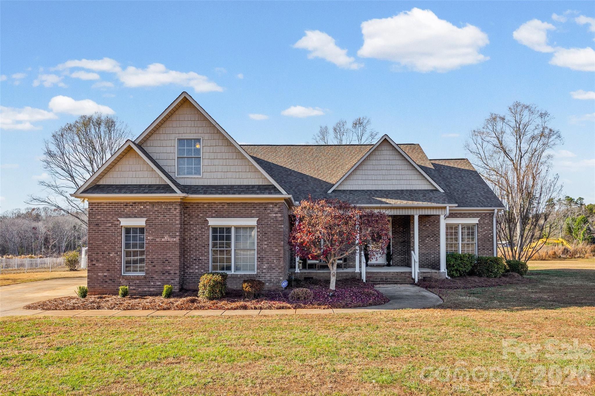 HUGE PRICE REDUCTION! This home in Clover combines space, practicality and luxury all in one wonderful location at an amazing price!  The large front porch welcomes you home, while the plantation shutters throughout and the  custom hardwood floors in the living area and dining room give you a luxurious feel.  The unique kitchen with Jenn-air range opens up to the breakfast nook all within view of built-in bookshelves that surround the gas fireplace.  If that is not enough, the French doors lead out to a bright sunporch and then onto a large deck with place for a swing and then an outdoor fire pit and living area.  There are even pecan trees and a fig tree in the yard!  The primary bedroom has tray ceilings, dual walk-in closets, a jetted tub, a walk-in shower and two sinks for convenience.  With the split plan, the other two bedrooms share a full bathroom and the bonus room upstairs offers a flexible space for anything you need.  Outside on the acre lot, you will find access to the well with a hand pump that can be attached and used, a charming fenced in area for a private garden, crepe myrtle trees and then there is an extra water storage tank in the crawl space. The two -car side load garage rounds out the property on a flat lot. You don't want to miss this special home near Clover schools and all that this convenient location has to offer!