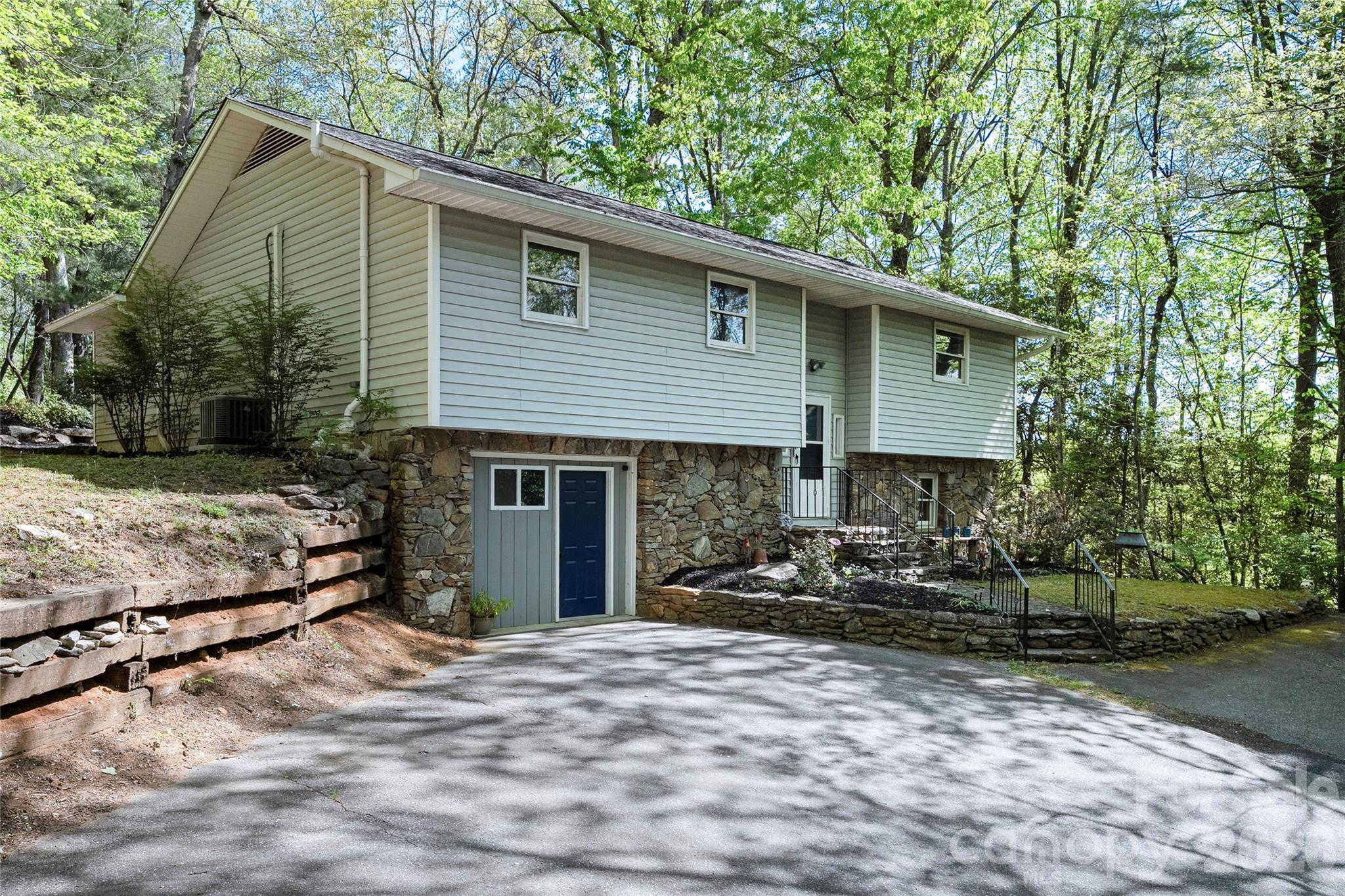 Welcome to 84 Chisholm St. This property offers space, flexibility and a peaceful wooded setting on approximately 1 acre, just minutes from downtown Saluda. This three-bedroom, two-and-one-half-bath split-level residence features 2,331 square feet with hardwood, luxury vinyl and carpet throughout the main living areas. Kitchen was recently updated and new paint in main bathrooms.  The primary suite is an oasis that includes an expansive adjoining sitting room that can serve as a home office, study or private retreat.  Step outside the primary bedroom to enjoy the Aqua Living G6 Tranquility hot tub surrounded by mature oak trees and natural privacy.  The finished basement provides an ideal secondary living space for entertaining, movie nights or game-day gatherings. Relax on the back deck with a cup of coffee or grilling out with family. Laundry is located in the finished basement with an additional hookup available in the main level sitting room. Built in 1986, this home combines comfort and versatility with easy access to Saluda’s restaurants, specialty shops, art and music venues, plus nearby outdoor recreation including hiking, biking and mountain adventures.  Located one mile from Interstate 26 and 15 minutes from downtown Hendersonville. Very Motivated Seller!  Come discover what 84 Chisholm St. has to offer.