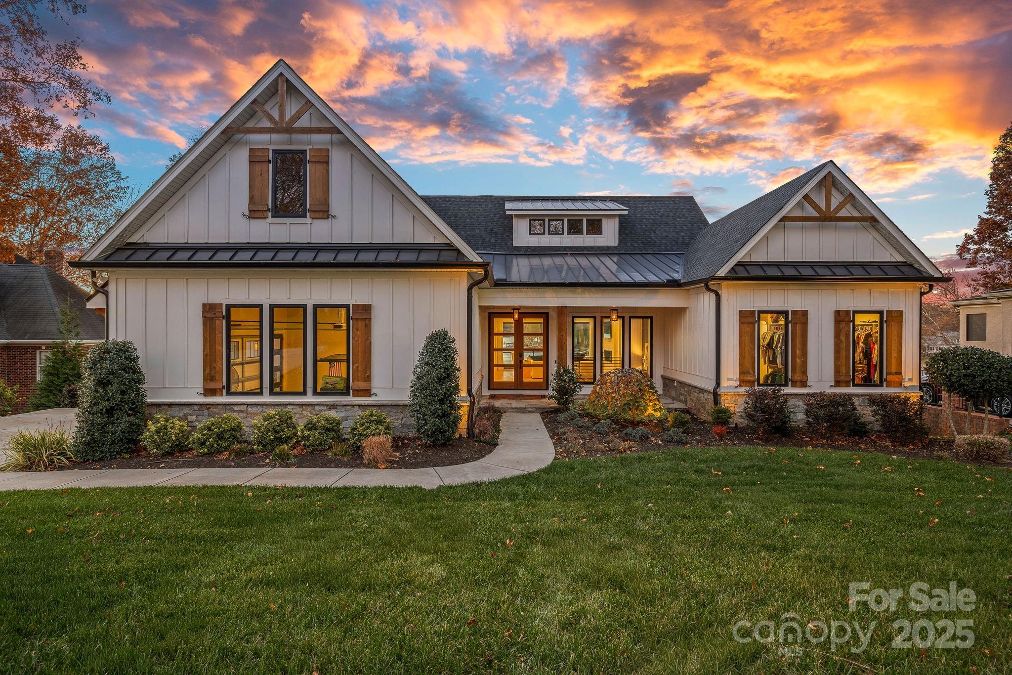 Exquisite Waterfront Custom Home on Lake Norman. Discover luxury lakefront living at its finest in this newly built 4-bedroom, 4-bath masterpiece on a quiet cove in Mooresville. Designed with timeless craftsmanship and modern innovation, this home showcases authentic cedar beams, black Andersen casement and powder-coated storefront windows, and a striking mix of black standing seam metal and rustic black shingle roofing.  Great room features vaulted ceilings with cedar beams and a 60" direct bent linear Gas fire box with reflective midnight crushed glass operated with remote control for added convenience.  The heart of the home opens through expansive 16’ and 12’ Windor multi-slides to breathtaking water views, leading to a resort-style backyard featuring a pool with bar stools, hot tub,  tanning ledge, and waterfall edge. Enjoy evenings on the screened porch off the owner’s suite with a stone fireplace overlooking the lake. The outdoor living area continues with a Silver Travertine patio, outdoor fireplace, and private dock with boat slip and lift.
Entertain with ease in the chef’s kitchen featuring custom cabinetry, hidden pantry, and Spectrum Inspiration quartz countertops with a 3” mitered waterfall island. Premium appliances include a KitchenAid 48" dual-fuel gas range, built-in dishwasher, microwave drawer, and Frigidaire Professional 33" refrigerator and 33" freezer columns. The basement-level wet bar offers a sink, dishwasher, and space for a 36" refrigerator—perfect for entertaining family and guests.  The main-level owner’s suite offers a serene retreat with a spa-style bath—zero-entry shower, dual showerheads, and Cambria Clovely quartz surfaces. Additional features include Control4 smart home automation, custom feature walls, solid white oak flooring, epoxy-finished garage floor, spray foam insulation, and a tankless gas water heater with recirculation system.
Enjoy year-round outdoor living with covered and screened porches, flagstone patios, professional landscape lighting, and lake-fed irrigation. This home seamlessly blends refined design, premium materials, and Lake Norman’s signature waterfront lifestyle.