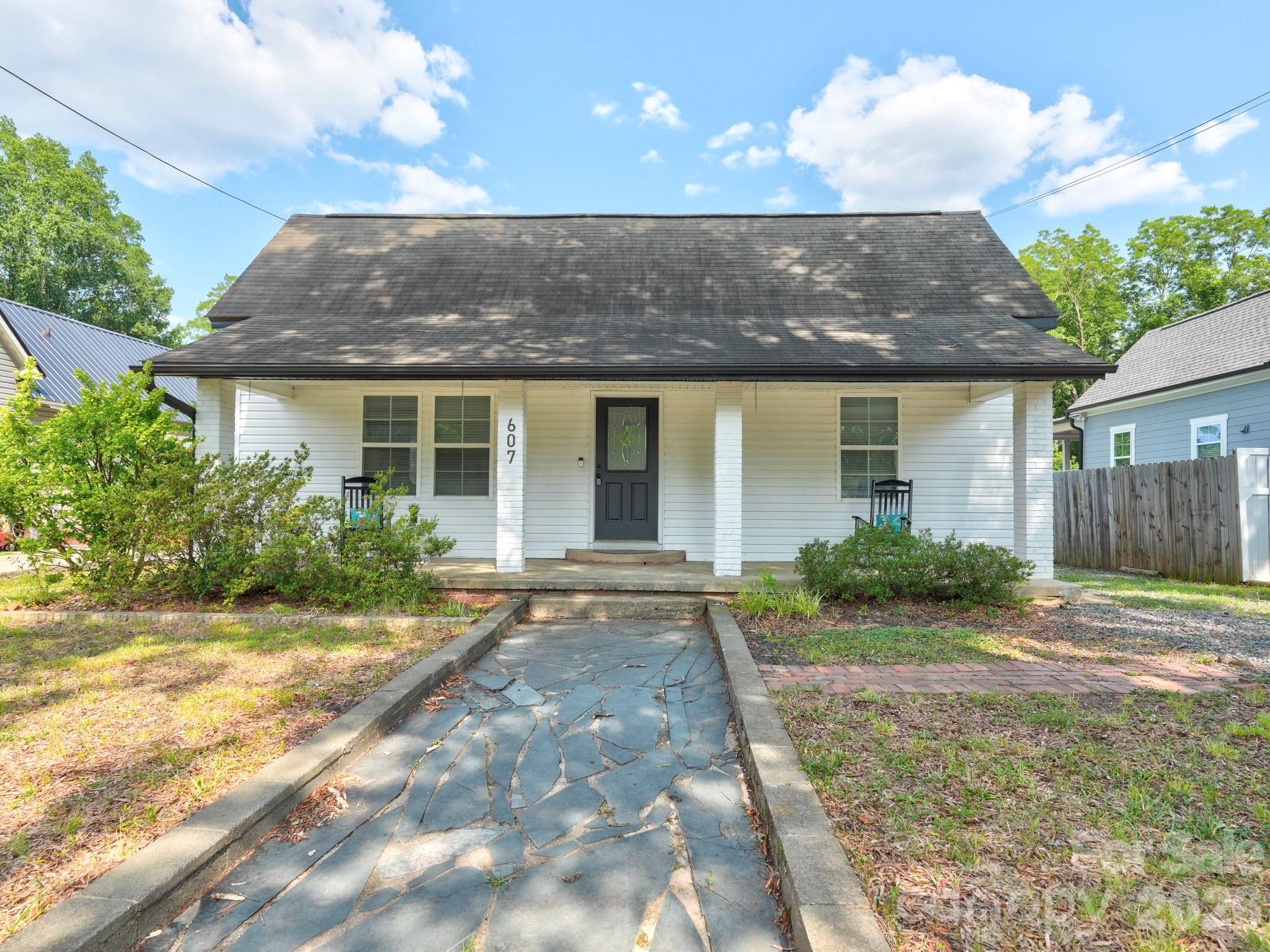 Vintage charm is paired perfectly with modern convenience in this stylishly updated home in booming Concord. Relax on the rocking chair front porch, or on the back deck overlooking the fenced yard. Inside, the living areas are spacious and offer flexibility. A front living room opens to den/dining space and then to the kitchen. It has white cabinetry, granite countertops, stainless appliances and a roomy island. There are 3 bedrooms and 2 renovated baths, including the primary suite with walk-in closet and private bath. LVP flooring throughout, with no carpet. This home is turnkey, with all appliances remaining, including washer/dryer, and a new water heater. This home lives large, and offers a value under 300k. Central location with multiple ways to get to I-85, and just a five minute drive to downtown Concord. Welcome home!
