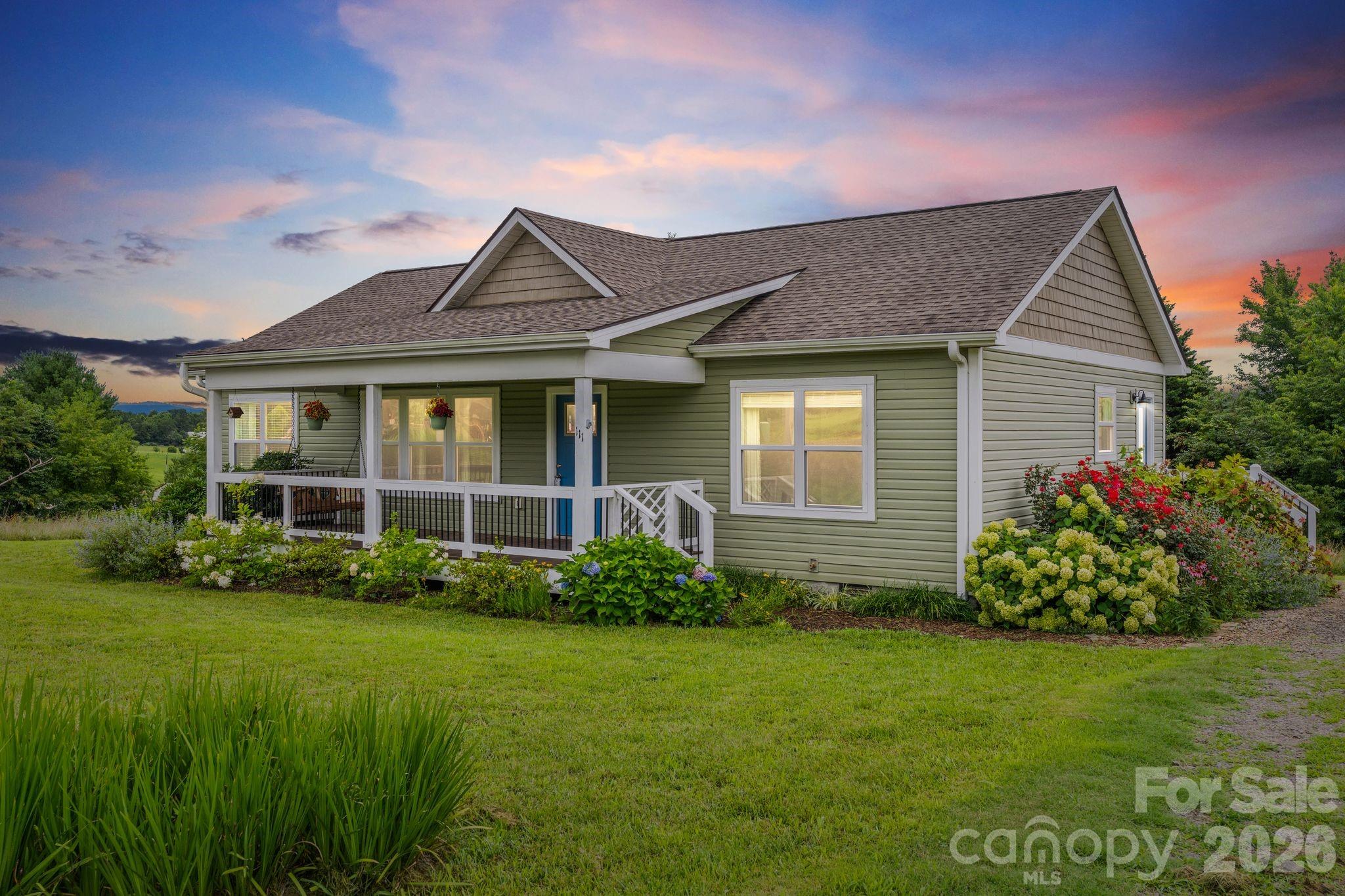 Welcome home to this beautifully maintained 2019 Craftsman nestled on a quiet cul-de-sac, offering nearly an acre of picturesque property with peaceful views—all just minutes from Asheville and convenient access to I-26. Tucked away from the main road, this inviting home provides the perfect balance of privacy, comfort, and convenience.

Inside, you'll find a bright, open-concept floor plan with soaring vaulted ceilings, rich hardwood floors throughout, and a desirable split-bedroom layout. The spacious kitchen is designed for both everyday living and entertaining, featuring granite countertops, ample cabinetry, and seamless flow into the main living area.

The generous primary suite offers a relaxing retreat with a double vanity and plenty of space to unwind. Thoughtful upgrades throughout the home include custom pantry shelving in the mud/laundry room, a smart A/C system, and custom pull-down blinds in every bedroom.

Step outside and enjoy everything this property has to offer. Sip your morning coffee on the covered front porch, grow your own vegetables in the two raised garden beds, gather around the brick fire pit on cool evenings, or take advantage of the 10' x 20' storage building with electricity—perfect for a workshop, hobby space, or additional storage.

If you've been searching for modern living with room to breathe, beautiful surroundings, and a location that's close to everything while feeling worlds away, this exceptional property is one you won't want to miss.
