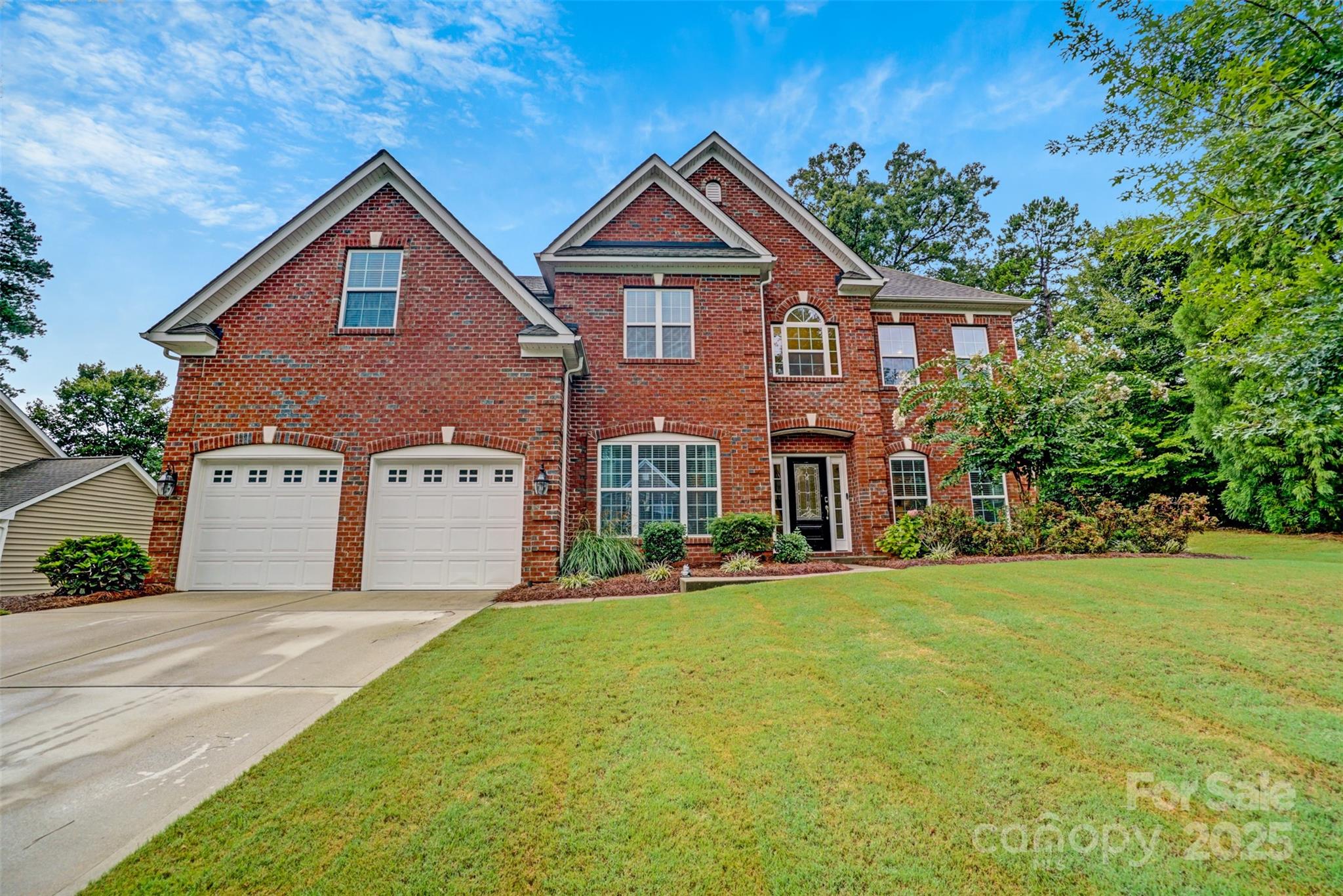 **Sellers are offering up to $10,000 in incentives** This BEAUTIFUL home offers 4 bedrooms, 3.5 baths and over 3,800 sq. ft of living space. Enjoy all the formals—living room, dining room, and family room—designed for gathering, relaxing, and making memories. The main level showcases a lovely 2 story foyer, gleaming hardwood floors with dual staircases. Front staircase upgraded to hardwood stairs. Spacious kitchen with an oversized island, serving as the centerpiece of the room, generous counter space, and plenty of cabinets with under cabinet lighting. Upgraded lighting package in the kitchen, dining room, foyer and upstairs bathrooms. All bedrooms have ceiling fans. Upstairs features 4 bedrooms and a large bonus room that can be used as a 5th bedroom. Large primary bedroom includes a sitting area. The primary bathroom offers separate vanities, an oversized upgraded frameless shower, garden tub and a large walk-in closet. Head out back and enjoy the outdoors on the extended 21x13 patio, complete with beautiful paver stones and a built in grill. The exterior uplighting shows the true beauty of the home at night. The community features include a swimming pool, pool house, walking trails and playground area.