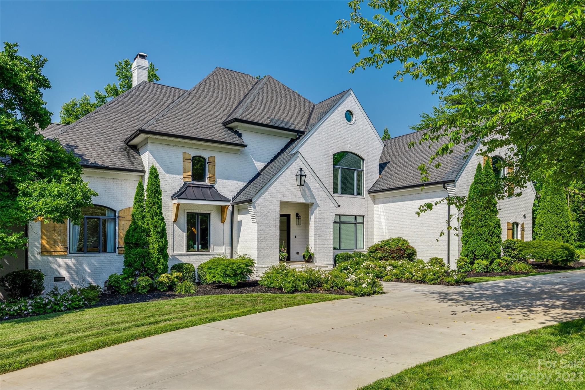 Incredible opportunity to own this Axios Charlotte and QC Exclusive 2020 Home of the Year! Beautifully positioned on 1.7 acres in the tranquil community of Patrick's Purchase, this waterfront home is an entertainer's dream come true. Renovated down to the studs this home offers almost 9,000 sq. ft of heated living space complete with its own indoor racket/basketball court, heated salt water pool and spa. Double glass doors welcome you as you enter the two story foyer with curved staircase trimmed in elegant white and black tile. Custom high-end finishes greet you in every room and compliment the home's neutral color scheme. Stunning gourmet kitchen with oversized T-shaped eat-in island, ILVE Majestic range and Viking wall ovens. Relax on the new second story deck overlooking mature landscaping & gorgeous Lake Norman views. The gazebo, pier and dock with two boat lifts offer the perfect setting to watch the sunset.