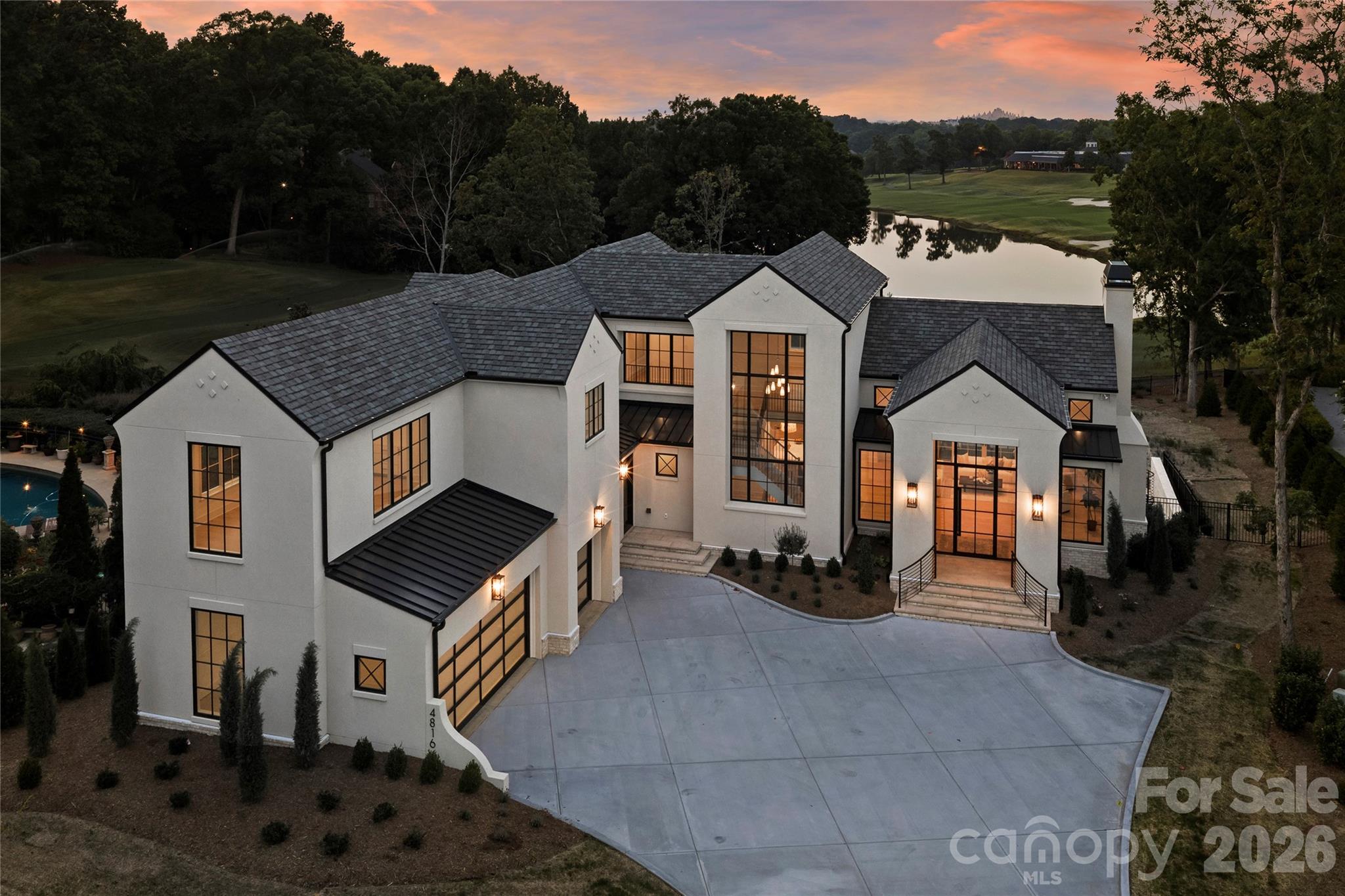Perched overlooking a breathtaking panoramic vista of the 17th green, the shimmering lake and the Piper Glen Clubhouse, this newly constructed custom estate is a true architectural masterpiece. Spanning over 8,000 square feet, the residence offers a rare synergy of timeless design, flawless craftsmanship and resort-inspired amenities. Designed to maximize natural light and celebrate seamless indoor-outdoor living, this home greets you with soaring ceilings,, dramatic floor-to ceiling windows, and rich, organic textures. The result is an atmosphere that is simultaneously grand and deeply inviting, effortlessly balancing high-end entertaining with comfortable daily life. The main floor features a sanctuary-like primary retreat, complete with lavish marble bath and custom dressing room. At the heart of the home, the chef's kitchen is a culinary dream, appointed with premium appliances, a dedicated scullery, an expansive walk-in pantry, a central island, and a casual dining area. The sprawling gathering spaces flow out to a covered porch equipped with outdoor kitchen/grill, fireplace, heaters and motorized retractable screen for year-round enjoyment. The upper level features three beautifully appointed en suite bedrooms, a vaulted bonus/game room and abundant storage. The lower level is an entertainment oasis, designed for ultimate leisure, featuring a game room with linear fireplace, a full-service walk-in bar, a fitness room, a state of the art golf simulator room, a pool bath with a steam shower, and a private home office( convertible to a 6th bedroom) alongside an elegant guest retreat. Outside an architectural pool, integrated spa, and custom fire pit create a private oasis back dropped by the golf course. Located just a short stroll from the clubhouse, this iconic estate balances refined luxury with effortless livability. Welcome to vacation living, every single day.