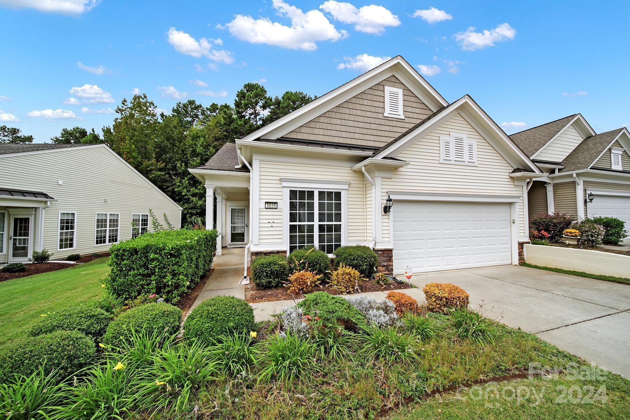 Move-in ready, end-unit Muirfield Villa w/ brand new LVP flooring, carpet, & fresh paint! This villa has 2 bedrooms, 2 bathrooms, a den area, & a screened porch that leads to the back deck. You'll immediately notice the prominent crown molding & wainscoting accents! Use the den as a home office or 2nd living space! The great room offers lots of natural light & ample space for easy living. Cook meals in the kitchen with the SS appliances, and enjoy your dinner at the bar or in the dining nook! The primary bedroom features carpet and a bathroom w/ a dual-sink vanity, a glass enclosed shower, & a walk-in closet. Unwind in the screened porch or on the rear deck while enjoying the wooded view! Don't miss out on this adorable villa with great location to the front entrance, shopping center, & restaurants. Come join the active adult lifestyle that Sun City has to offer, including a golf course, 2 amenity centers, tennis & pickleball courts, pools, & so much more!