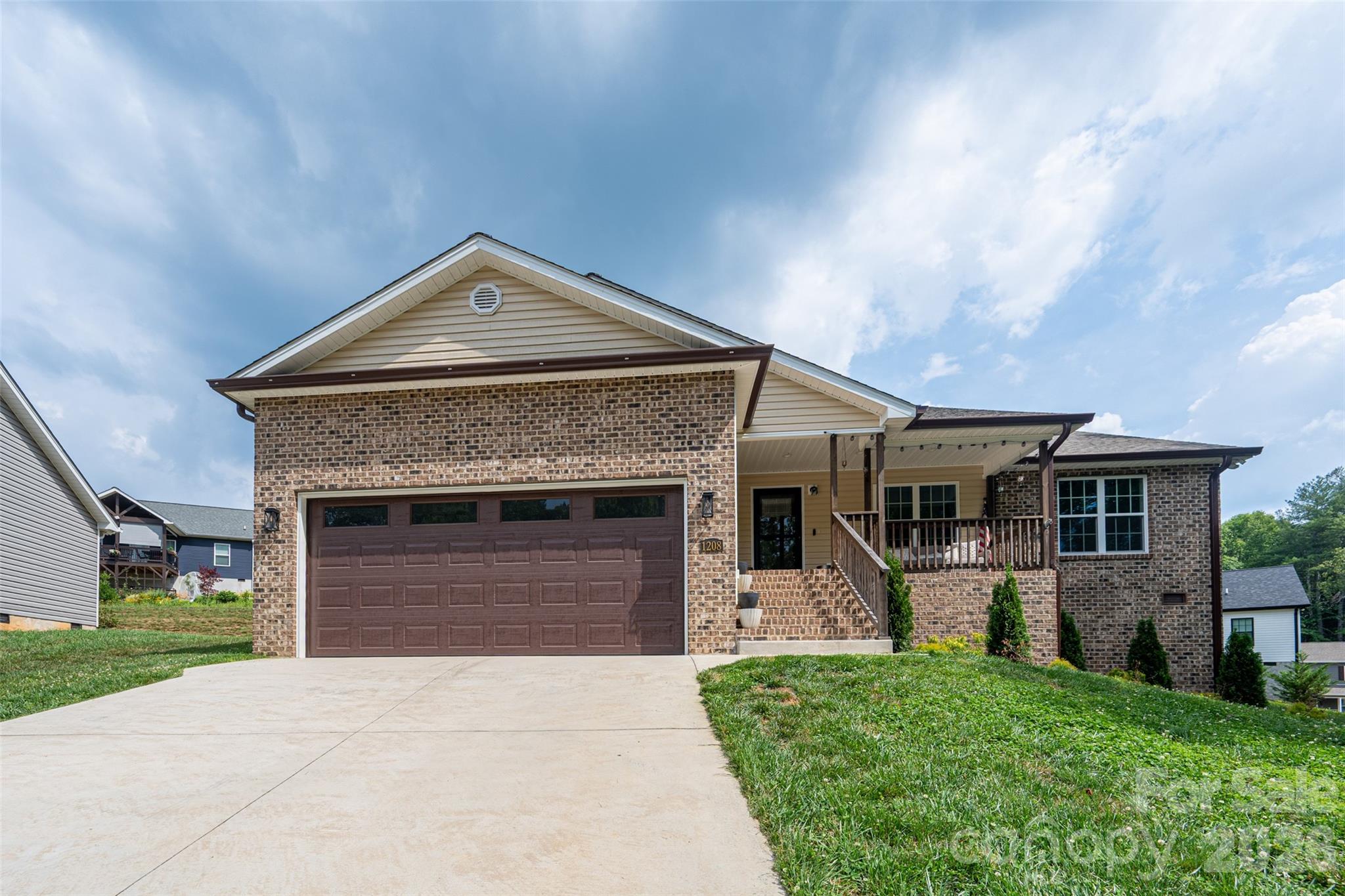 Beautiful home in desirable Summerhill in Lenoir, NC, conveniently located near Hwy 321 with easy access to Boone, Blowing Rock, and Hickory. This well-maintained home offers a spacious open layout with a large living room featuring a tray ceiling, recessed lighting with dimmer options, and great natural light throughout. The kitchen includes stainless steel appliances, granite countertops, subway tile backsplash, and easy access to the outdoor patio.

The split-bedroom floor plan provides privacy, with a spacious primary suite featuring a large walk-in closet, double vanity, and walk-in shower. Two additional bedrooms offer double-door closets and share a full bathroom. Tasteful finishes include upscale vinyl flooring, soft neutral paint colors, and clean white trim throughout. The laundry room is conveniently located near the garage. Enjoy the inviting front porch overlooking a green area of the subdivision, with mountain views possible on clear days. Tall crawl space offers great additional storage. - Professional photos coming soon