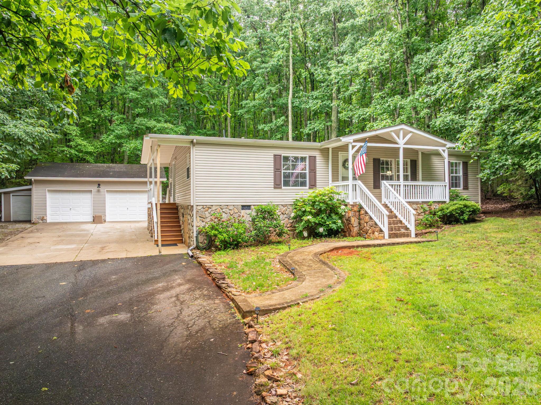 BACK ON MARKET AT NO FAULT OF THE SELLERS. Welcome to peaceful living in the sought-after Mount Anderson area of Maiden. Tucked away on a beautifully wooded lot, this move-in-ready home blends privacy, comfort, and thoughtful updates with custom character throughout.

Recent improvements include all-new luxury waterproof vinyl flooring, fresh paint on walls, ceilings, and trim, updated lighting, refinished kitchen cabinetry, refinished fireplace mantel, new locks and updated door hardware throughout, new closet shelving, updated electrical outlets, and beautifully refreshed bathrooms featuring new cabinetry, countertops, toilets, and faucets.

The spacious open-concept layout offers comfortable everyday living with abundant natural light, a cozy fireplace as a focal point, and seamless flow among the kitchen, dining, and living areas. The kitchen includes new GE stainless steel appliances — refrigerator, stove, dishwasher, and microwave — along with a Whirlpool washer and dryer that will remain with the home.

The primary suite features custom wood accents, extensive built-in cabinetry, and a warm, inviting retreat feel rarely found at this price point. Outdoor living shines with covered porches, a screened back porch, mature trees, and peaceful wooded surroundings, creating a true mountain-style retreat.

Additional system upgrades include new PEX water lines, a new water heater, a new water filter at the pressure tank, and a new pressure regulator for added peace of mind.

A detached two-car garage/workshop with electrical service adds exceptional versatility, with ample room for parking, storage, hobbies, or workspace needs — a rare bonus in this setting.

Enjoy the peace of a private residential setting while remaining convenient to shopping, dining, and schools, with easy access to Hickory, Lincolnton, and Charlotte. This property offers updated living, natural beauty, and custom charm all in one unique package. Septic Pumped, Survey, Clear Well Water Test, Clear WDII Inspection in Jan 2026.