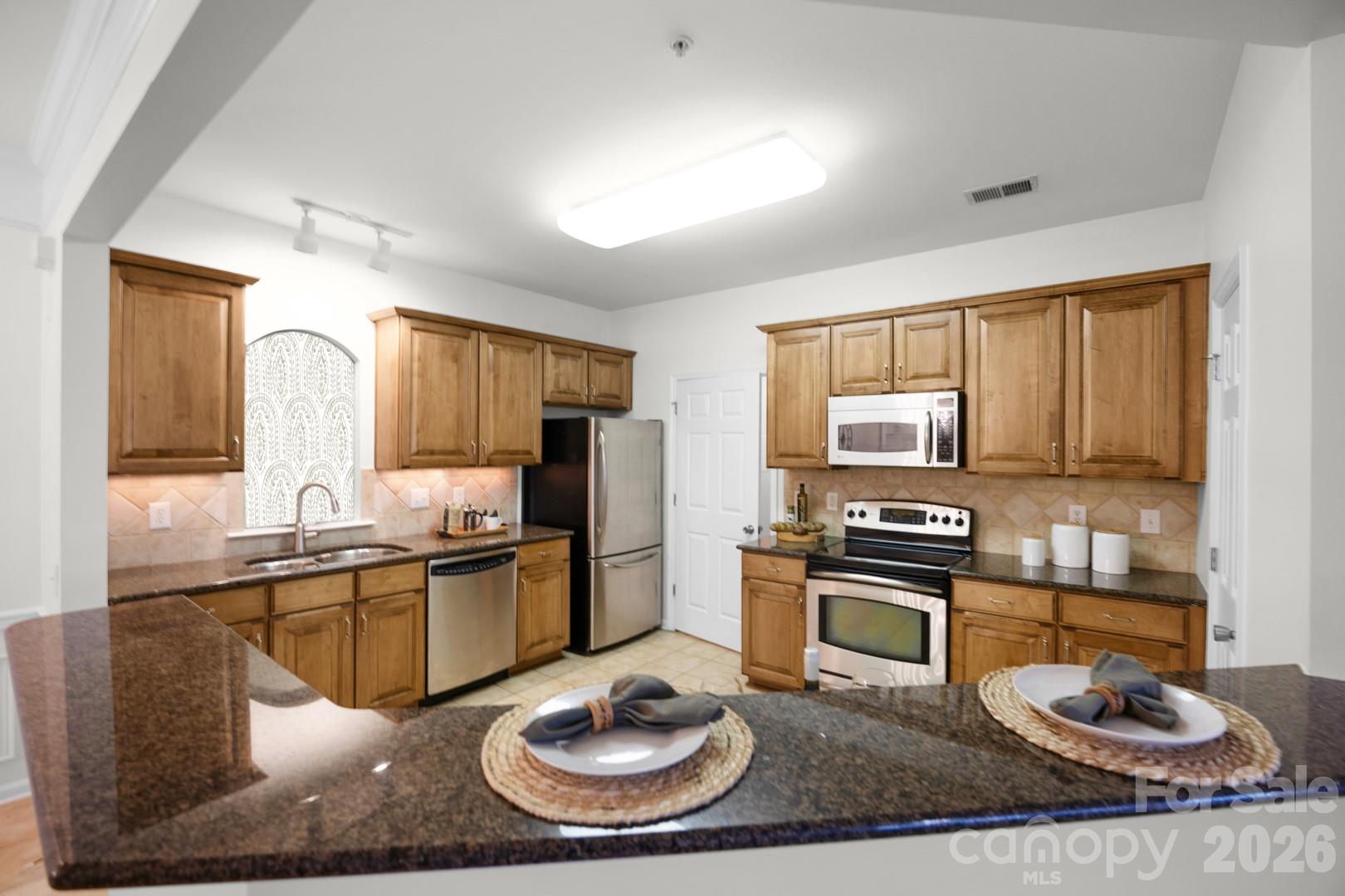 Renovated Condo!  Amazing location, with easy access to highways, shopping, and dining. This unit is better than new. Kitchen with stainless steel appliances, granite counter tops, and a backsplash.  The flooring was upgraded hardwoods.  The bathrooms have fresh faucets, and fixtures.  Fresh paint throughout complete the renovations.  Truly move in ready!
