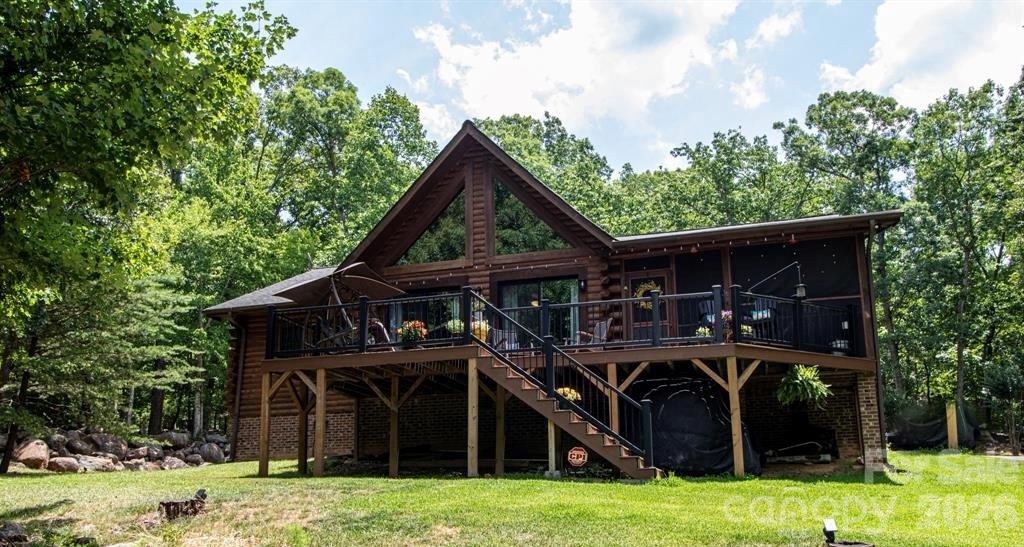 Nestled on just under 3.5 acres sits the perfect combination of classic & cozy! This gorgeous log cabin home located in gated community of The Springs at High Rock brings the best of lake living with all the amenities!! Whether you’re looking for your next new home, or just a vacation getaway…this is it!! Recently renovated kitchen includes spacious island/breakfast bar, quartz counter tops, stainless appliances (all included) plus pantry; see through fireplace leads into the vaulted great room featuring sitting and dining area with double door access to maintenance free deck. Spacious primary en-suite is well equipped with walk-in closet, dual vanities, and private entrance to screened-in porch. Split plan includes 2 additional guest bedrooms & full bath. Convenient laundry area (washer & dryer included) and a new 20x30 back deck that is an outdoor oasis for just relaxing or entertaining with family and friends! New windows 2023, HVAC 2022, front sliding doors 2024, front deck & railing 2023, back deck 2025, just under $10k in crawlspace improvements 2026. Full list of additional home upgrades available. Stunning Clubhouse, swimming pool, pickleball courts, community boat slips, boat storage, community boat ramp, walking trails, and so much more! Call us today for a tour!!