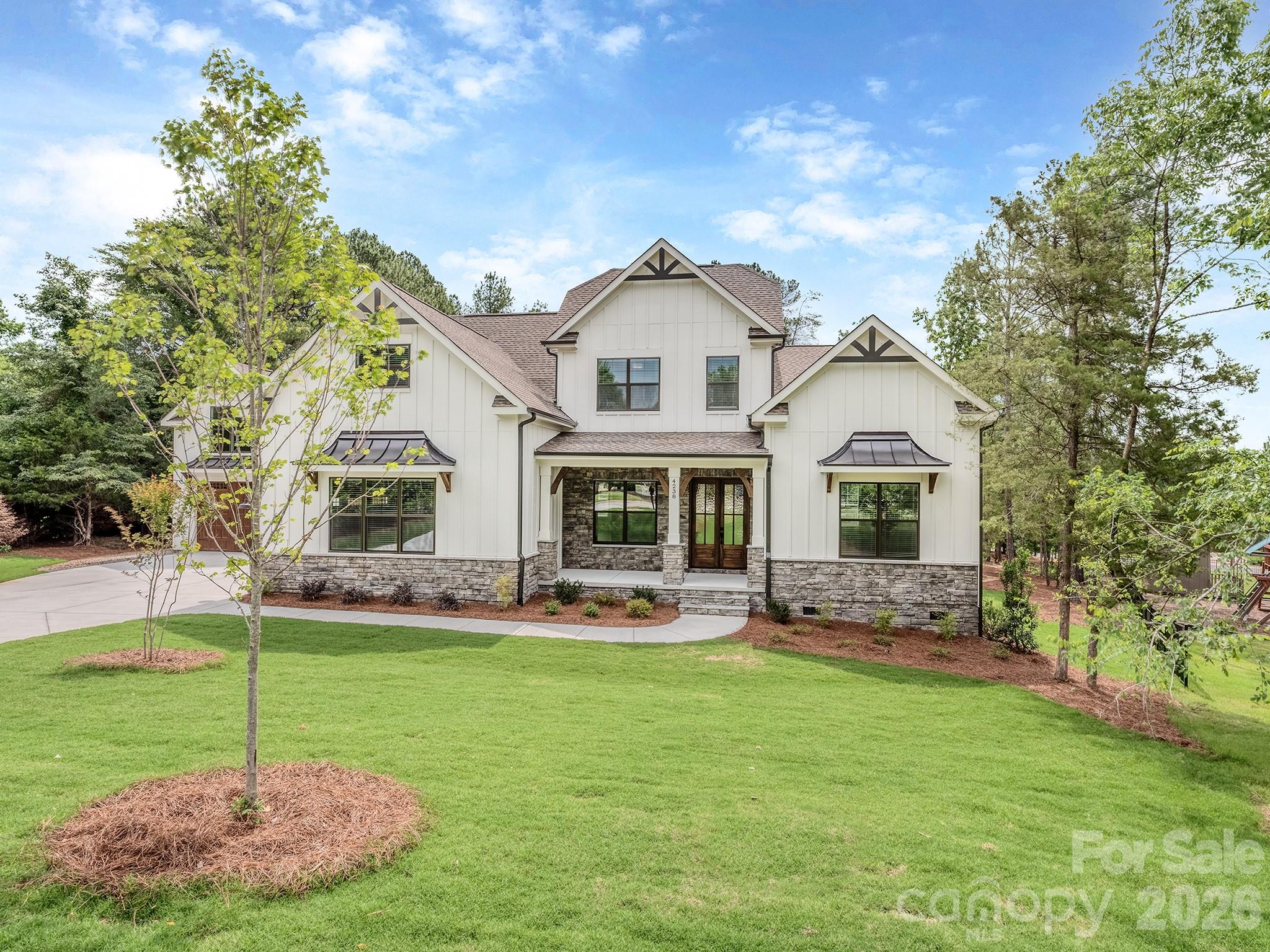 Beautiful new construction in The Glades at Windswept Cove. This 4-bedroom, 3-1/2 bath home features a rare flat 1.47ac lot perfect for a pool and wooded for privacy.  The first floor has a spectacular open kitchen and breakfast, great room with fireplace, vaulted keeping room, drop zone leading to laundry room, home office, primary bedroom with large bath and closet, a spacious covered deck with fireplace, and a 3-car garage.  The 2nd Fl features a bedroom with ensuite bath and 2 bedrooms connected with a jack and jill bath, large bonus room featuring a homework desk and plenty of storage. This home also includes structured wiring for networking, speakers and security. The Glades at Windswept Cove is one of Lake Wylie's premier custom communities, providing a quiet atmosphere while being just minutes from top rated Clover schools, restaurants, and shopping. The home will be complete and ready to close in May 2026...