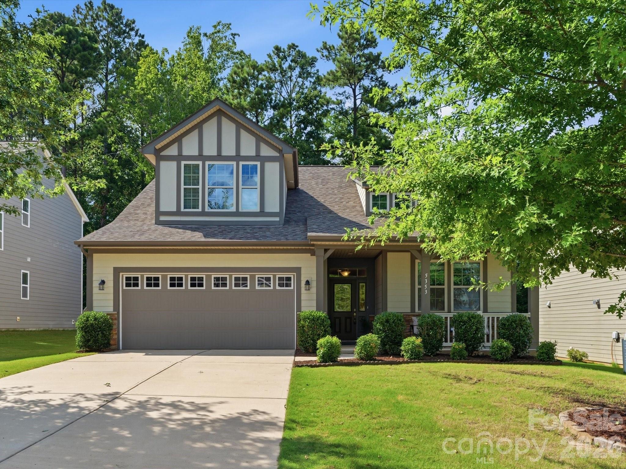 Beautifully designed 3-bedroom, 2.5-bath home featuring an open-concept floor plan with the primary suite conveniently located on the main level. Thoughtful upgrades throughout include 9-foot ceilings, 8-foot doors, and a private home office perfect for remote work. The spacious kitchen offers granite countertops, a large walk-in pantry, and a dedicated desk area in the home center. The expansive great room has a cozy gas fireplace—ideal for both entertaining and everyday living. The main-level primary suite features a private en-suite bath with dual vanities, granite counters, a large walk-in shower, linen storage, and a generous walk-in closet.  Upstairs, you'll find two additional bedrooms, a full bath, and a versatile bonus/flex room that can be used as a media room, playroom, home gym, or second office.
The exterior has durable Hardie plank siding and striking stone accents. Enjoy added privacy in the backyard, which backs to a wooded area, creating a peaceful, natural setting. The property also includes an attached two-car garage equipped with a Tesla EV charger, making it ready for modern living. Residents also have access to fantastic community amenities including a pool, playground, and walking trail.
Located in the highly regarded Clover School District, this home combines comfort, style, and convenience!