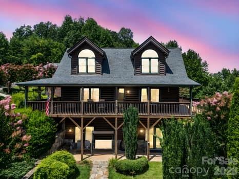 Enjoy the peace and tranquility of this stunning mountain top retreat. The spectacular views are truly breathtaking. There are year round views of Grandfather Mountain, Pilot Mountain and all the surrounding Blue Ridge Mountains. The morning sunrises and evening sunsets can be viewed from the wraparound covered porches and decks. The 2.29 acres are beautifully landscaped with flowering plants and trees. Upon entering this custom log cabin it is evident this is a one of a kind cabin and location. It is tastefully decorated and immaculately maintained. There is plenty of room for friends and large family gatherings. Above the detached garage is a full apartment with it's own kitchen , fireplace and deck.  If you have been wanting a NC mountain top property this is it! The Hidden Lake community features a pool and jetted spa, a fishing and paddling lake ,  hiking trails and a creekside park. Only 9 miles to I-40 but a world away. Make your NC mountain dreams come true.