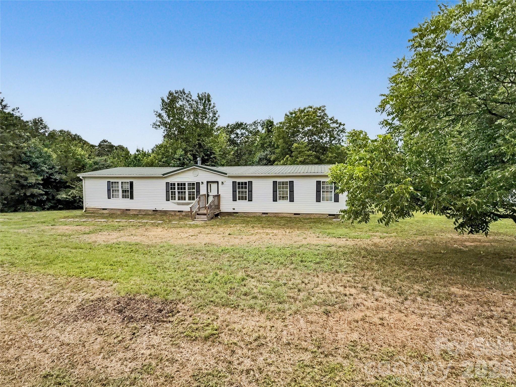 Escape the restrictions of HOA living and enjoy the freedom you've been looking for on nearly an acre in one of Waxhaw's most desirable locations. Enjoy the independence of having your own private well—no monthly water bills and no county water usage restrictions. You'll have greater control over your water supply while saving money month after month. This property offers the space and flexibility to truly make it your own, whether you dream of gardening, entertaining, or simply enjoying the privacy and peace of country-style living.

Inside, you'll find a spacious open floor plan featuring 3 bedrooms and 2 full bathrooms. The oversized living area with fireplace flows seamlessly into the dining room and kitchen, complete with a breakfast bar that's perfect for gathering with family and friends. A separate laundry/utility room adds convenience, while the private primary suite offers a relaxing retreat with dual sinks, tub, separate shower, and a large walk-in closet. Two additional generously sized bedrooms and a full bath provide plenty of room for family, guests, or a home office.

Step outside and discover a fenced garden area ready for your vegetables or flowers, mature trees, added privacy, and nearly an acre of land to enjoy however you choose.

Located just five minutes from charming Downtown Waxhaw, you'll have quick access to local restaurants, breweries, boutiques, parks, and the small-town atmosphere that makes Waxhaw one of the area's most sought after communities.

If you've been searching for a place where you can spread out, enjoy fewer restrictions, and embrace a simpler way of living, this is your opportunity. Come experience the freedom to live life on your terms.
