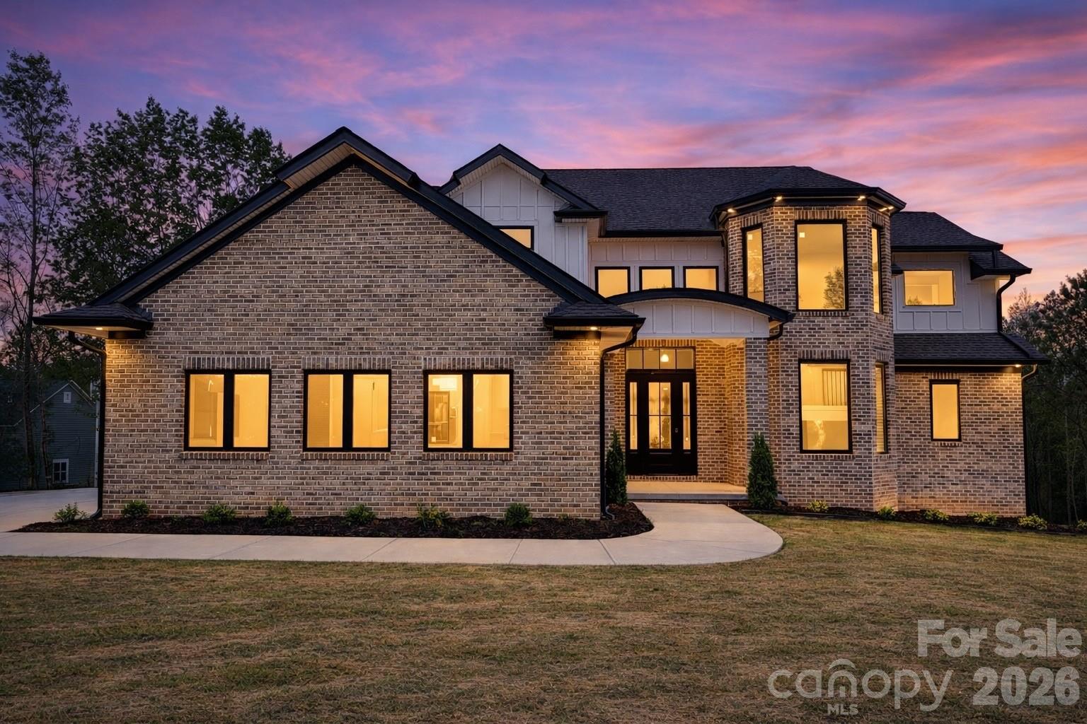 Welcome to Catawba Shore Estates, an exclusive enclave of upscale estate homes offering privacy, elegance, and refined living just outside of Charlotte. This newly constructed 2026 luxury residence is perfectly positioned on a private 1.08-acre wooded homesite, delivering a rare blend of modern design, functional layout, and executive-level lifestyle.

Thoughtfully designed with 4 bedrooms and 4 full bathrooms, this home features a highly desirable primary suite on the main level, ideal for both convenience and long-term living. The open-concept floor plan is elevated by a dramatic two-story living room, anchored by a stunning 6-foot electric fireplace wrapped in floor-to-ceiling porcelain, creating a sophisticated focal point and a warm, modern ambiance.

At the heart of the home, the gourmet kitchen showcases high-end Forno appliances, including a gas cooktop, complemented by a striking 11-foot quartz waterfall island, full quartz backsplash, pot filler, and a spacious walk-in pantry. Designed for both functionality and style, this kitchen is ideal for entertaining, daily living, and creating memorable moments.

The main-level primary suite offers a true retreat, featuring a spa-inspired bathroom with a freestanding soaking tub, oversized walk-in shower, dual vanities, and a custom-designed closet.

A dedicated office on the main level provides the perfect work-from-home environment, complete with custom built-in shelving and its own elegant 6-foot electric fireplace, combining productivity with comfort and style—ideal for today’s executive lifestyle.

Outdoor living is equally impressive, with a covered patio and an additional lower-level patio overlooking peaceful wooded views—perfect for relaxing or entertaining while enjoying the privacy of your expansive lot.

Additional highlights include a 3-car garage, custom-built features throughout, and modern smart home convenience with a Nest thermostat. As a brand-new construction completed in 2026, every detail offers the advantage of new systems, finishes, and design.

Located approximately 40 minutes from Uptown Charlotte and 45 minutes to Charlotte Douglas International Airport, this home is ideal for relocation buyers and executives seeking space, privacy, and accessibility. Enjoy close proximity to Baxter Village and Kingsley (20 minutes), as well as everyday conveniences including shopping, dining, and major retailers just 10 minutes away.

Catawba Shore Estates is known for its estate-sized homesites, elegant setting, and private, executive-style atmosphere—making it a sought-after destination for those who value both luxury and tranquility.

This home is perfectly suited for relocation clients, executives, or luxury downsizers seeking a private retreat with modern design and proximity to Charlotte.
