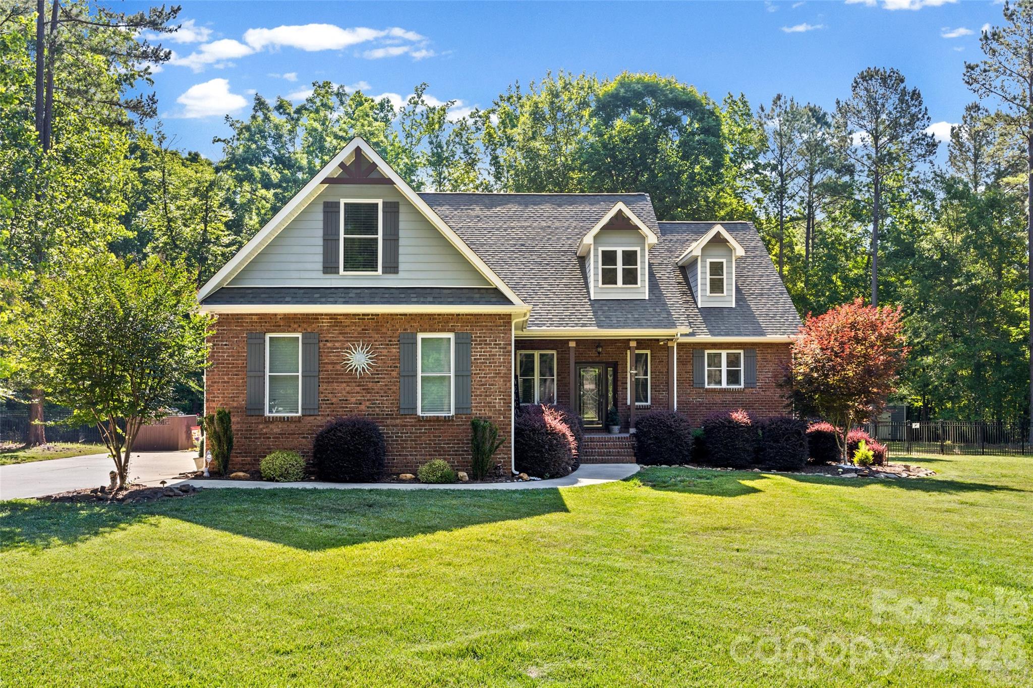 Welcome to this beautifully custom built full-brick gem on 5+ Acres in picturesque country setting in Clover. This home has been loved with care and style. As you enter, you'll be greeted by a two story entryway, open concept Great room with Custom built-in shelves & storage surrounding the two story stone fireplace with views to the tree-lined backyard. With a Chef's kitchen featuring high-end appliances, large island, beautiful countertops, custom cabinetry perfect for anyone who loves to cook or entertain. Plenty of room to gather in the eat in kitchen overlooking the private backyard. The open-concept layout flows with natural light, giving the living spaces a warm, inviting feel. The primary suite is a true retreat with 2 walk in closets, spa-like bath, soaking tub, double vanities and  a spacious walk-in shower is a perfect place to unwind. Upstairs find two bedrooms, full bathroom, an additional very large flex room over 2 car garage ideal for office, hobbies, or a great guestroom with a walk in closet. Outside, the landscaped, fenced yard is ready for everything from barbecues to quiet mornings with coffee on the relaxing screened porch and soak in the fabulous Custom 14 x 33 Fiberglass heated saltwater pool. The front porch & garage floor have epoxy covered floors. Custom built and so convenient, owners added  elevated overhead storage in garage. Top-rated schools! There are NO HOA only covenants, Can have an ADU but not room for it off the LEFT OF driveway but can be built on many other locations on the property. The septic is in the front yard. Plenty of room on the right, the back or off the back left behind the pool.