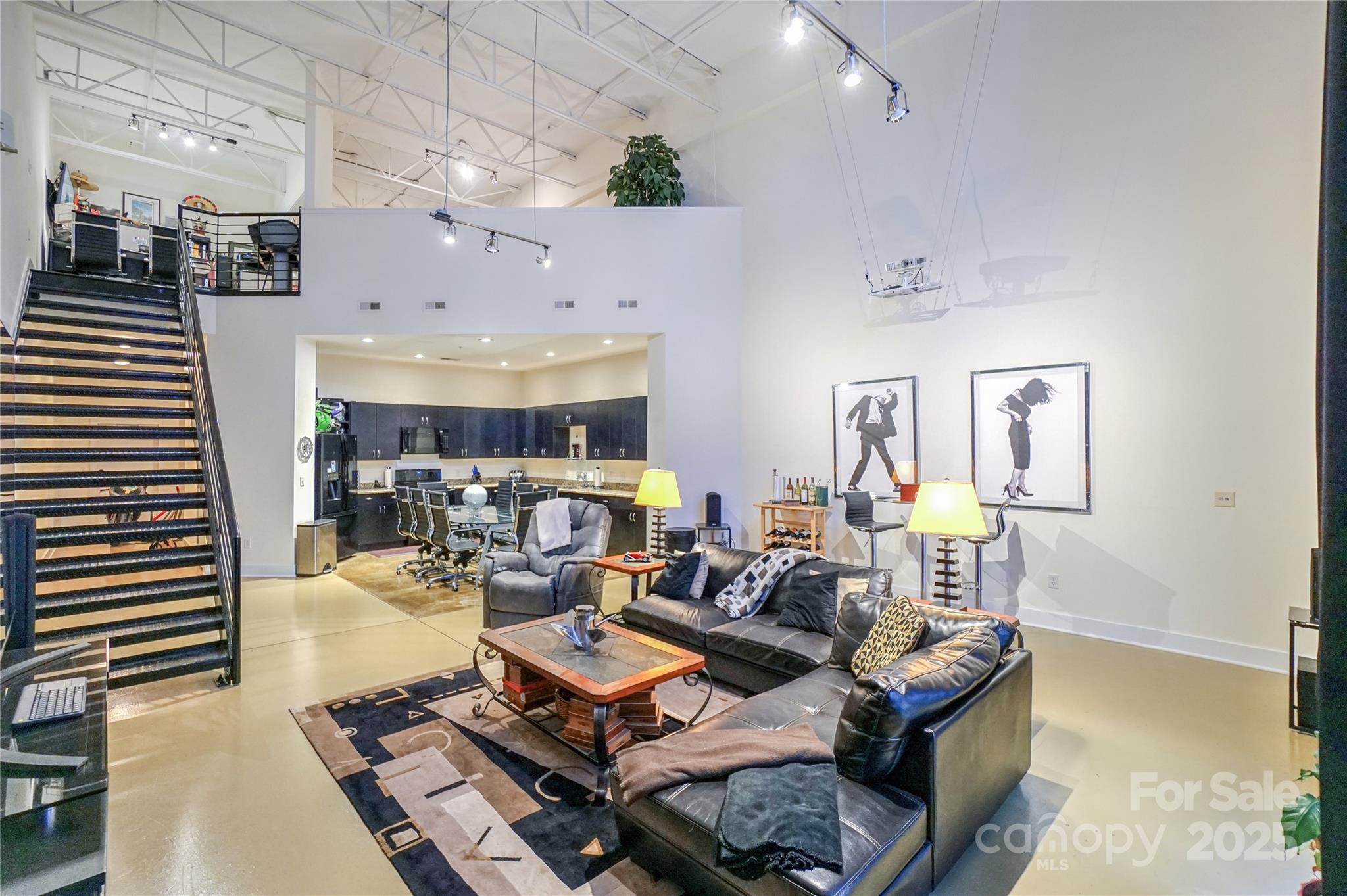 This live/work concept built in the 2007 building addition is an end unit. Features a huge 1,879 HSF. Perfect for your small business and your residence with full street access. The 2 BR 2 FB industrial style loft is the envy of uptown living, perfectly located in Third Ward. Walking distance of everything you can imagine. The space soars with 23' ceilings! Keyless entry with FOB at front door and Kevo bluetooth-enabled smart lock on the back door. Huge kitchen on the main level, bedroom and full bath with add'l access from the secured building entrance. Located as the first unit to the left. This home is an entertainer's dream for concerts, Charlotte Football Club and The Panthers. The upper level features an office, bedroom with large walk-in closet and en-suite.The primary bath features 2 pedestal sinks, a stand up shower and garden style soaking tub. Seller can include his Panther PSL’s Sec 508 Row 4 Seat 11,12 with good offer. VA APPROVED.