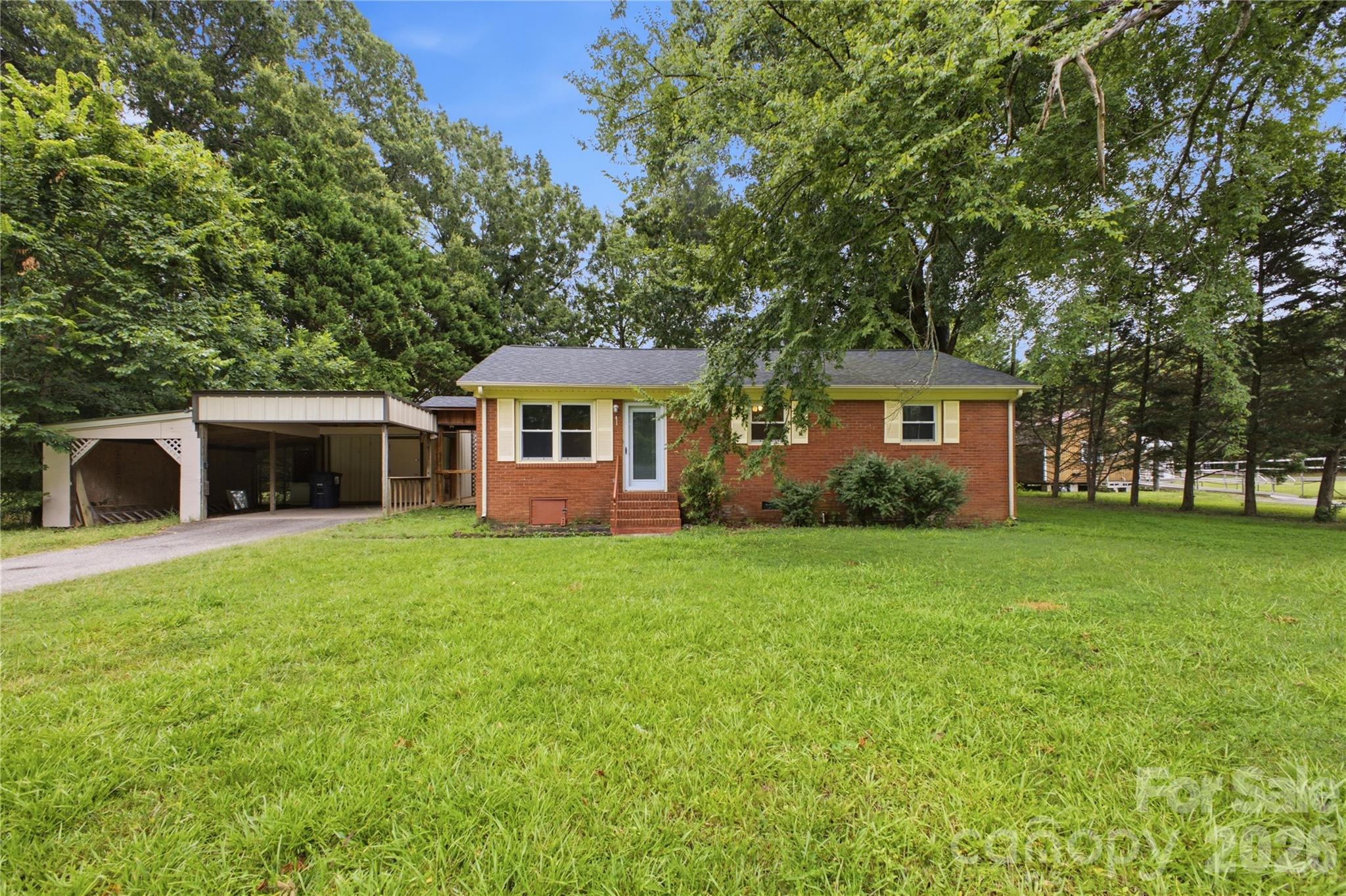 Charming all-brick ranch on a 0.34-acre lot in Indian Trail — NO HOA! This home is tucked back at the end of the street.  You'll love the privacy and the flat backyard.  With new interior paint including a fresh look for the kitchen cabinets, this home is worth the look for the money! Enjoy the large deck and bonus storage buildings, plus an attached carport.  Endless possibilities await. Established neighborhood just off Old Monroe Rd with easy I-485 access and Union County schools. A solid home — ideal for first-time buyers, downsizers, or investors. Bring your finishing touches and make it your own!  With multiple Down Payment Assistance Programs identified through Canopy's partnership with DPR, why rent?