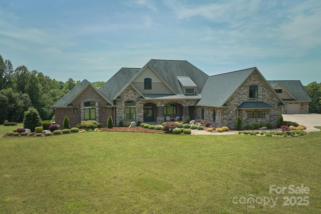 Experience luxury in this 8,210 sq ft masterpiece, designed for elegance and functionality. This residence boasts a main floor with 3 bedrooms, 3.5 baths, laundry room, and study. The master suite offers a private sitting area with breathtaking property views and a luxurious bathroom complete with heated floors. The open-concept layout seamlessly connects the gourmet kitchen—featuring custom cabinetry, oversized island and Thermador appliances—to a spacious living area with a stone gas fireplace that flows onto a balcony overlooking the private estate. The oversized bonus room includes a large bedroom and full bath. Custom ironwork railing leads you into the open concept 3,141 sq ft basement with exposed structural steel beams including kitchen, fitness room, additional room, and two full bathrooms. The outdoor oasis includes a swimming pool, hot tub, and a double-sided gas fireplace.
A detached 3-level garage reinforced with steel beams includes a bonus area above.
