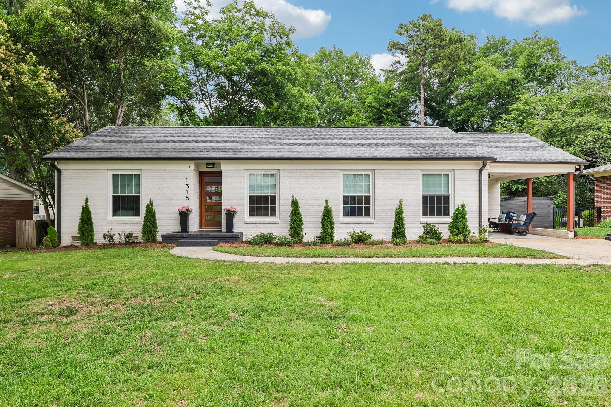 Completely reimagined and renovated, this exceptional Ashbrook residence blends timeless character, modern luxury, and an unbeatable location. Situated directly across from Park Road Shopping Center, enjoy walkable access to dining, shopping, coffee shops, and daily conveniences while being minutes from SouthPark, Uptown Charlotte, Atrium and Novant hospitals, the Light Rail, and Charlotte Douglas International Airport.
Inside, approximately 2,650 square feet of thoughtfully designed living space showcases an open floor plan, hardwood floors, designer lighting, and upscale finishes throughout. The chef's kitchen features custom cabinetry, quartz countertops, a large island, double ovens, professional-grade appliances, and abundant storage.
The primary suite offers vaulted ceilings, French doors opening to a private outdoor retreat, a custom walk-in closet, and a spa-inspired bath. Two additional bedrooms, including an ensuite guest suite, plus a dedicated office, provide flexibility for today's lifestyle.
Recent Updates: Roof 2021, Tankless Water Heater 2021, Mini split 2021, HVAC main home approximately 2017, Kitchen Aid Appliances 2021, Windows 2010 - transferable warranty
Outdoor living shines with a spacious patio, a fire pit, mature landscaping, privacy fencing, and multiple entertaining areas. Move-in ready and meticulously updated.
Seller is a Licensed Realtor.