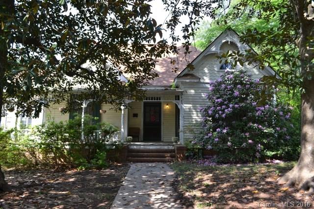 Charming ranch with large front porch. Formal dining room and great room, spacious kitchen with work island and double oven.  Home has two bedrooms, one full bath, and one half bath.  There is a flex room that could be used as a third bedroom using furniture pieces for closets.  Beautiful heart of pine flooring in many rooms. Some updated plumbing and wiring with 200 AMP service.  Home was built in the late 1800's.  Detached garage/workshop. AS IS SALE..