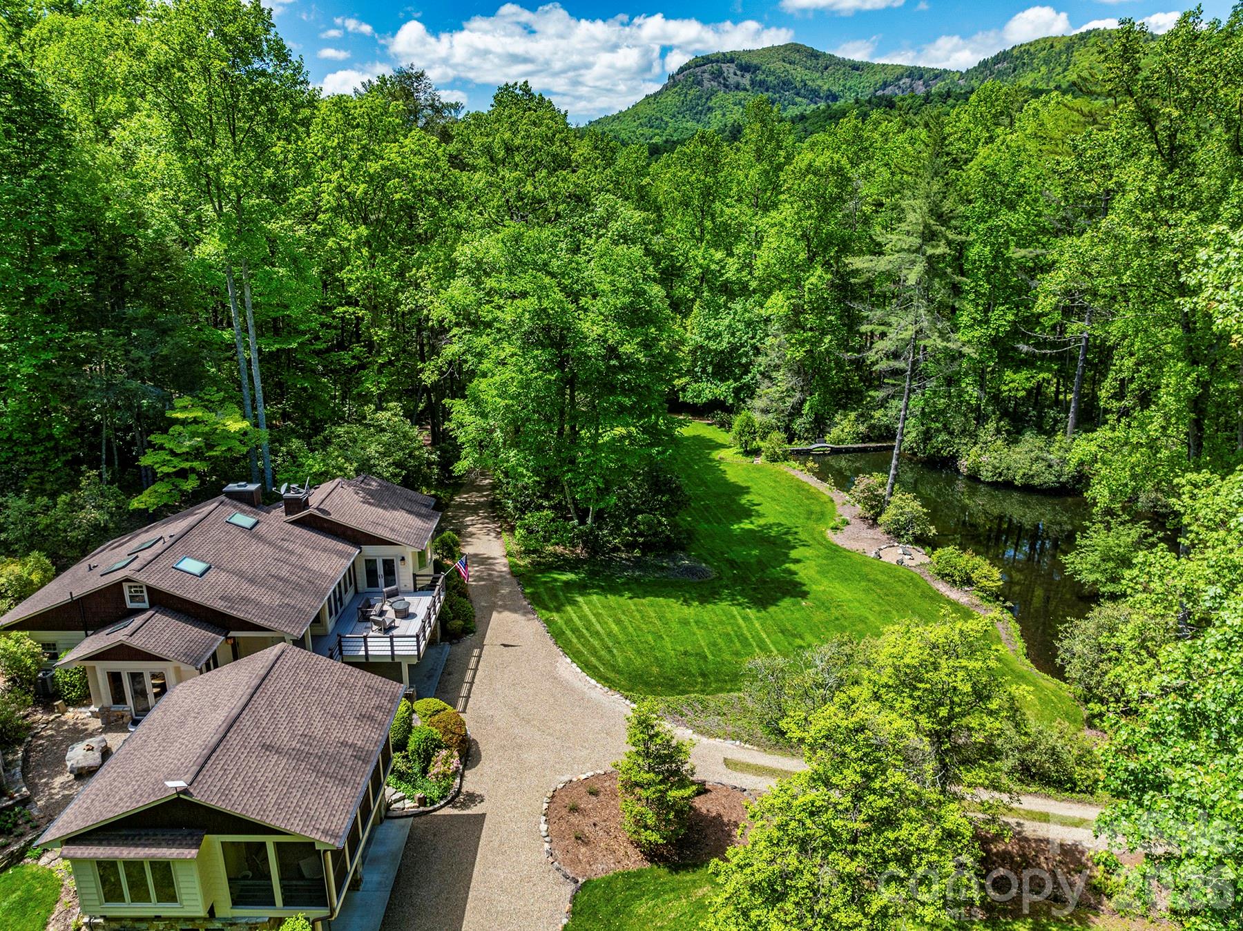 Experience the essence of luxury intertwined with nature in Cashiers, NC, within this charming Craftsman-style retreat. Encompassing 23.24 acres, this property offers a private pond, over 2 miles of hiking trails, and numerous building sites. With 3 bedrooms, 2 bonus rooms, 3 bathrooms, a stone fireplace, chef's kitchen, studio, and workshop, every comfort and creative pursuit is catered to. The home is fitted with new upgrades in 2023/2024 with Starlink internet, Kohler generator, new HVAC with air quality control, whole home dehumidifier, new water filtration system, new well pump, radon mitigation, and more! Outside, revel in serene pond views, gather around the outdoor fireplace, or unwind on the decks. Adjacent to Ellicott Rock Wilderness, near Whitewater Falls and Chattooga River's legendary Iron Bridge, and downtown Cashiers' vibrant art scene, a world of adventure and cultural exploration awaits. Seize this opportunity – schedule a tour today!